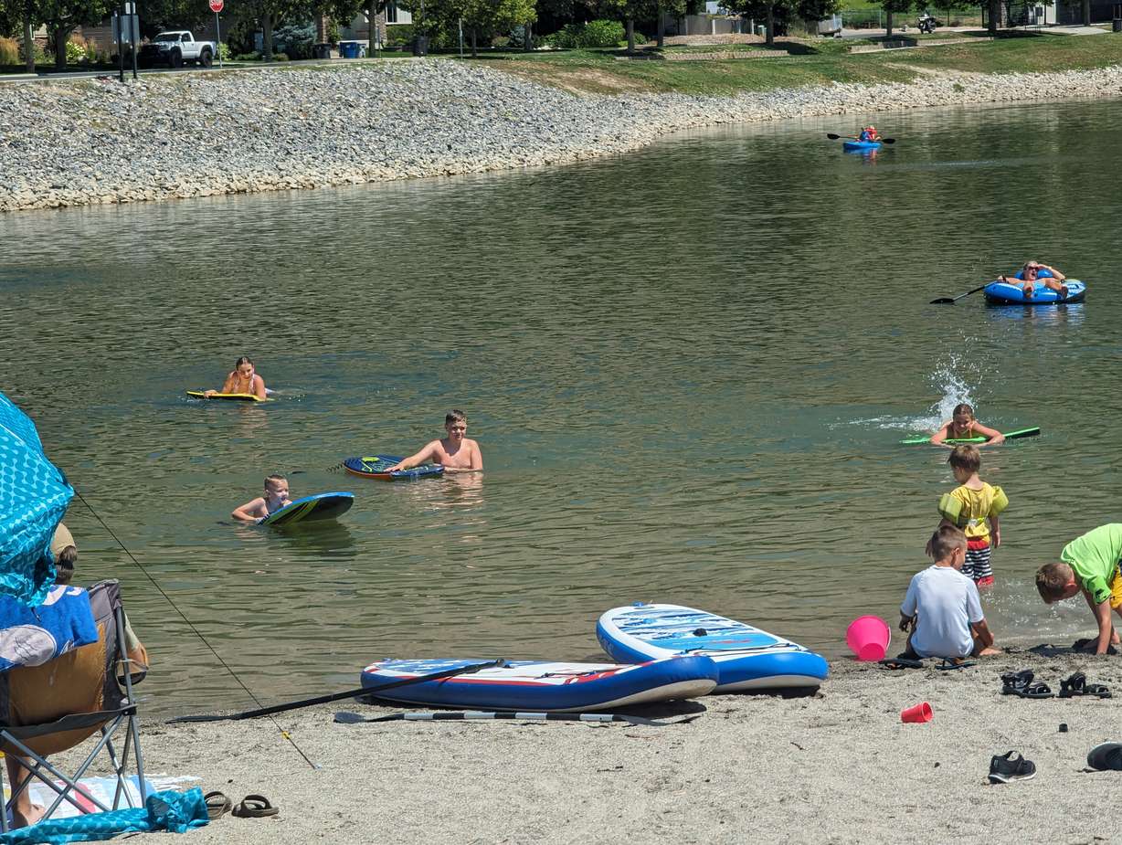 Kids swim and splash at Manila Creek Pond in Pleasant Grove, with many families unaware that a health advisory has been issued for the pond. Families say poor signage is not giving swimmers the warning they need to beware of possible E. coli in the water.