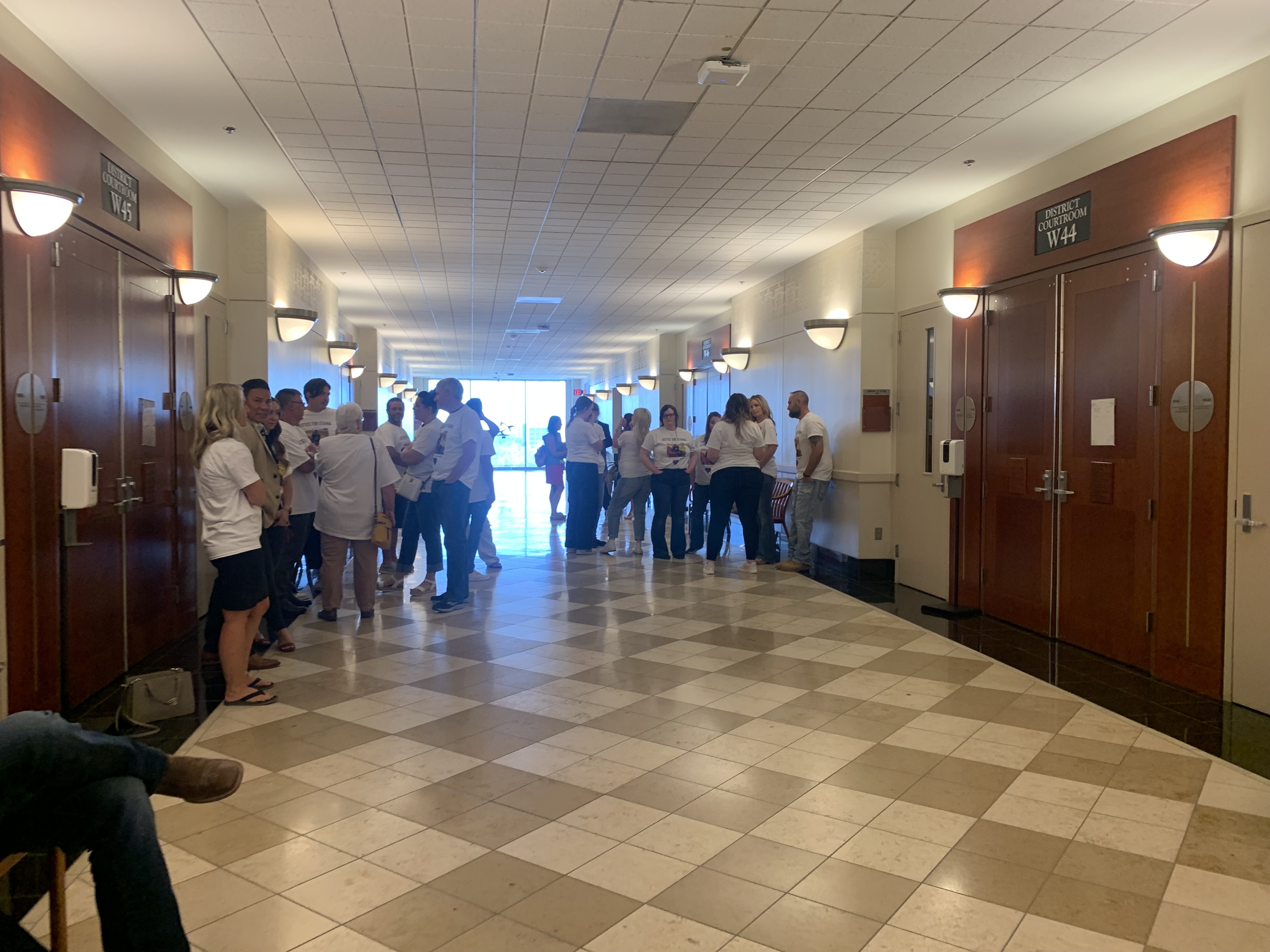 Family and friends of the late Utahna Halona wait in a court hallway on Wednesday prior to the sentencing of her husband, John Erickson, who pleaded guilty to her murder.