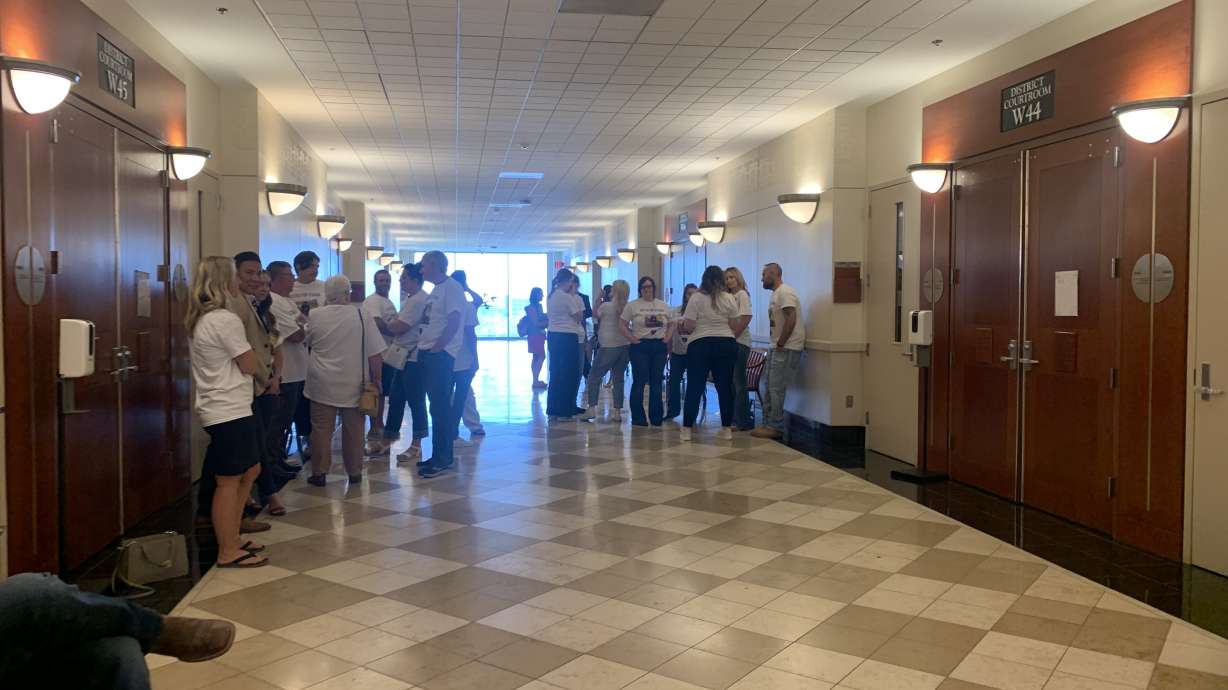 Family and friends of the late Utahna Halona wait in a court hallway on Wednesday prior to the sentencing of her husband, John Erickson, who pleaded guilty to her murder.