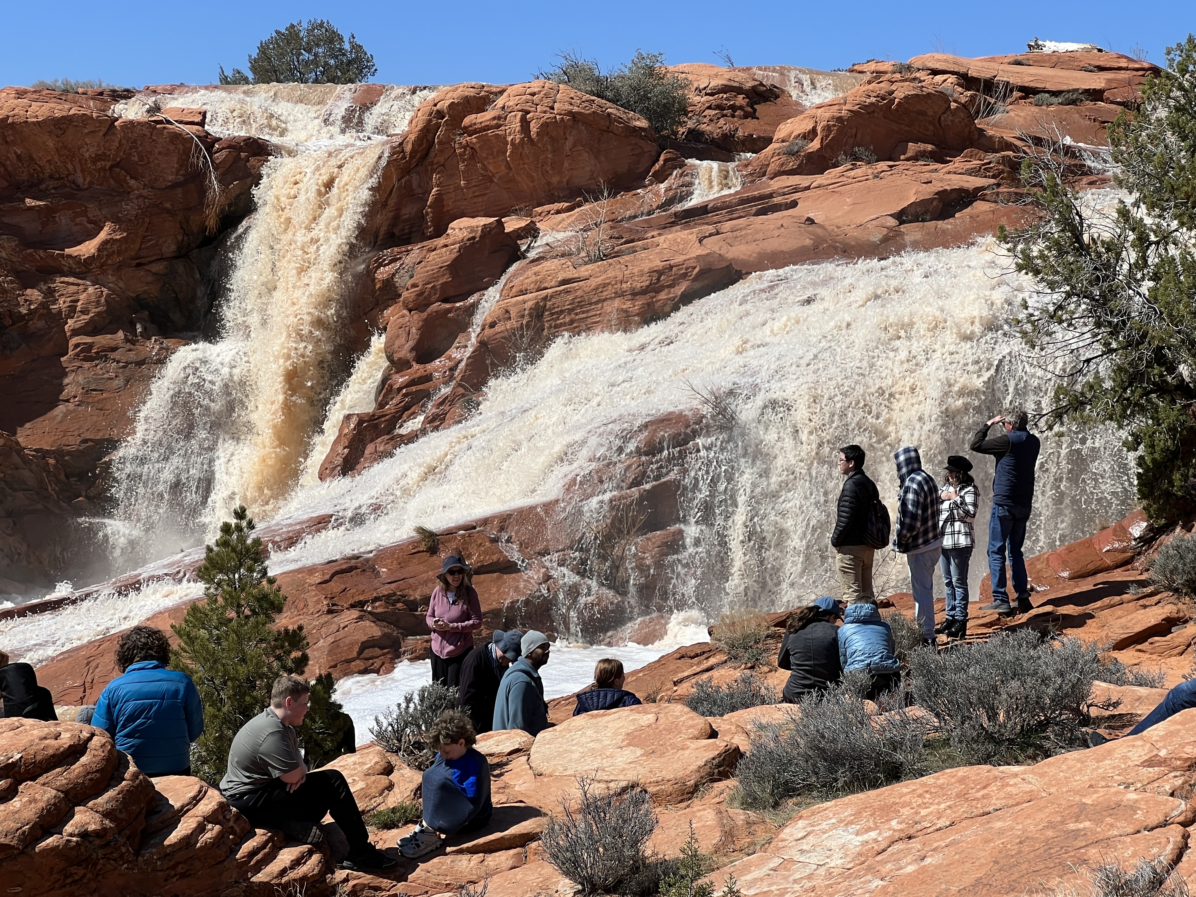 Visitors flock to the waterfall at Gunlock State Park on March 16. Officials are exploring price increases for out-of-state visitors after continued impacts of growing visitation.