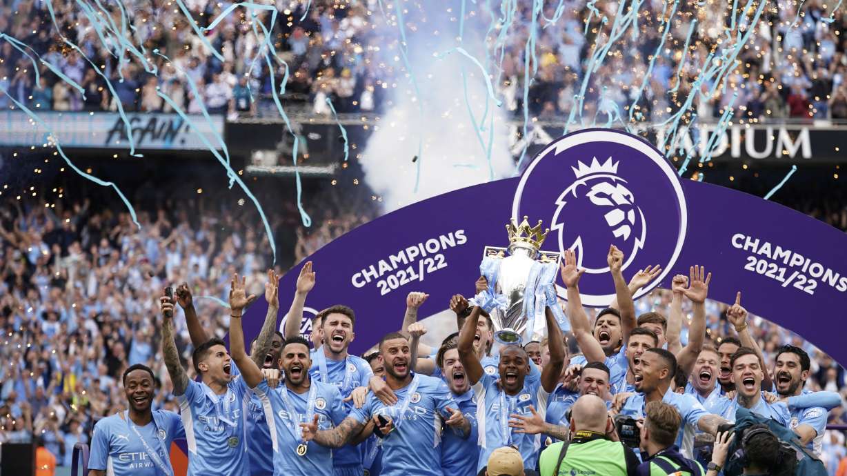 FILE - Manchester City players celebrate with trophy after winning the 2022 English Premier League title at the Etihad Stadium in Manchester, England, Sunday, May 22, 2022.