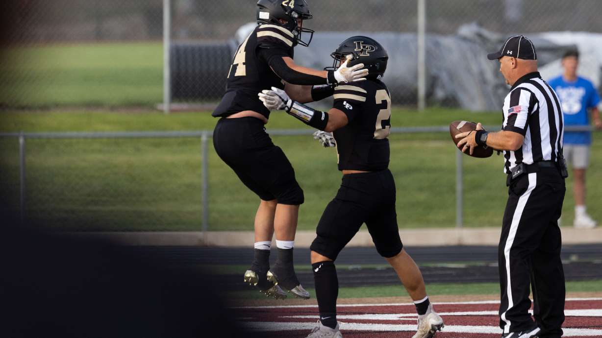 Lone Peak’s Brooks Wilde and Max Bateman celebrate after Wilde scores a touchdown in the high school football season opener against Bingham at Lone Peak High School in Highland on Thursday, Aug. 10, 2023.