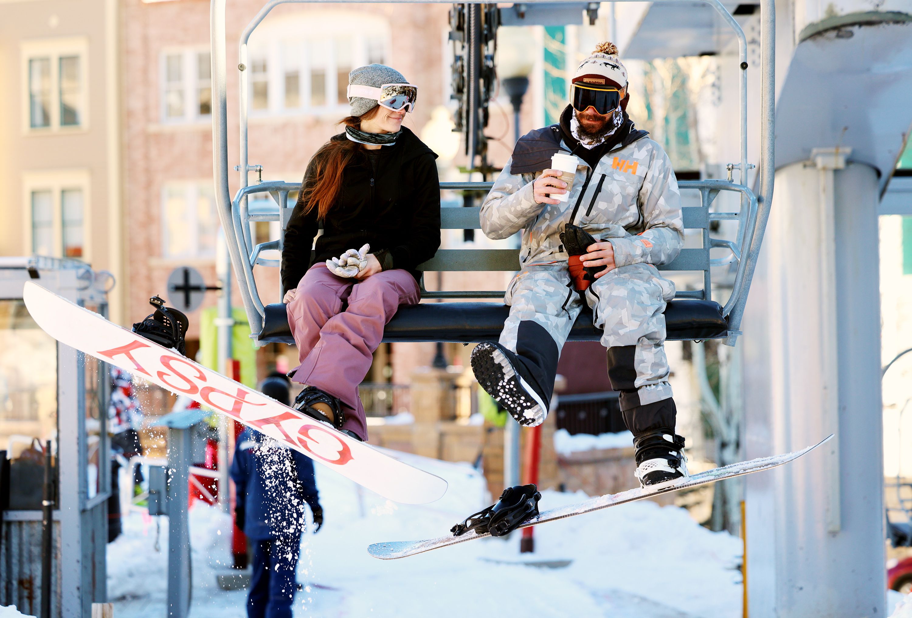 Snowboarders ride a lift in Park City on Jan. 11, 2022. OnTheSnow put together a list of places for individuals, couples and families who love snow sports to consider living.