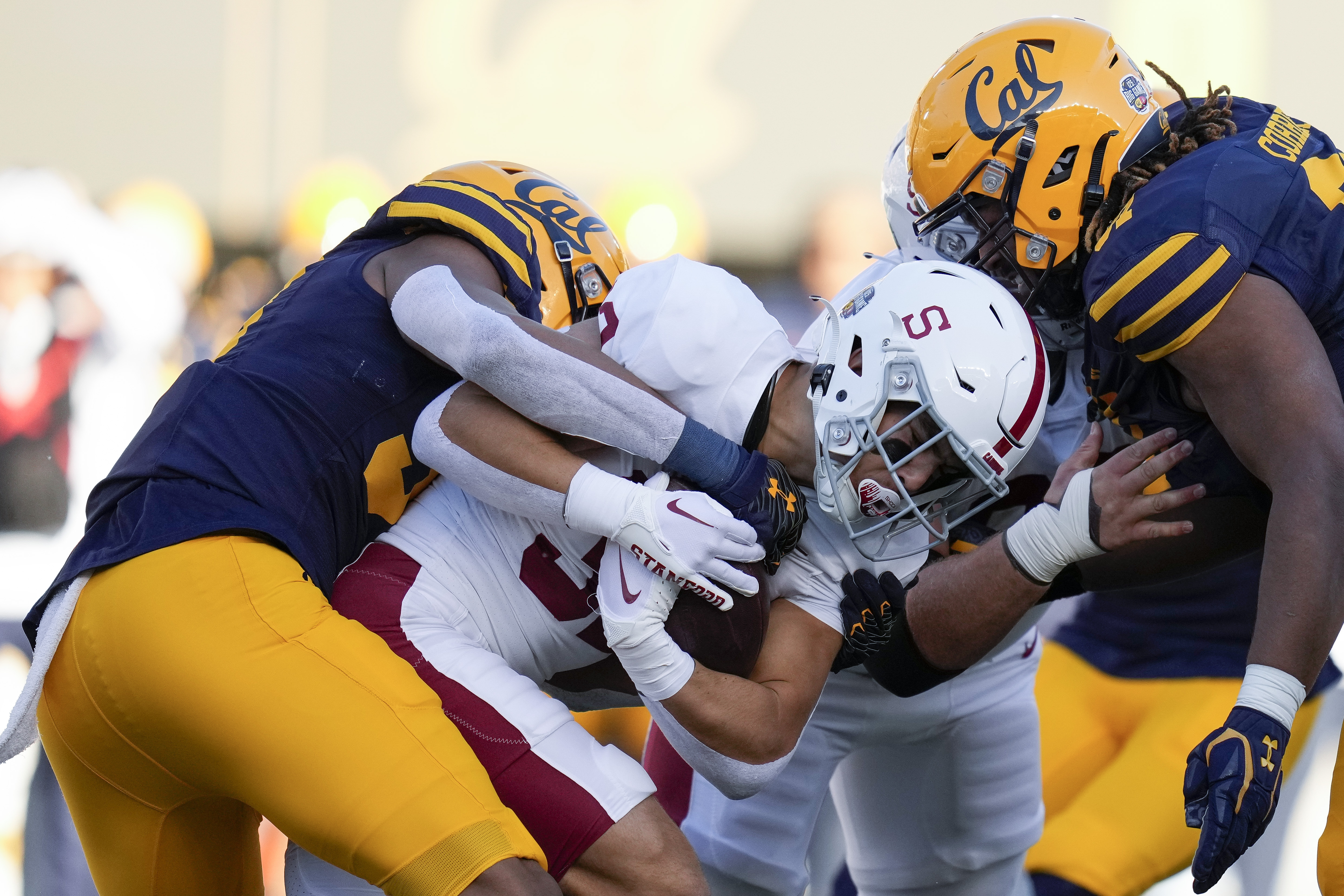 FILE - Stanford running back Mitch Leigber, middle, runs the ball against California during the first half of an NCAA college football game in Berkeley, Calif., Saturday, Nov. 19, 2022. Atlantic Coast Conference presidents and chancellors held a conference call Tuesday, Aug. 8, 2023, but took no action on West Coast expansion with California and Stanford, a person with knowledge of the situation told The Associated Press. 