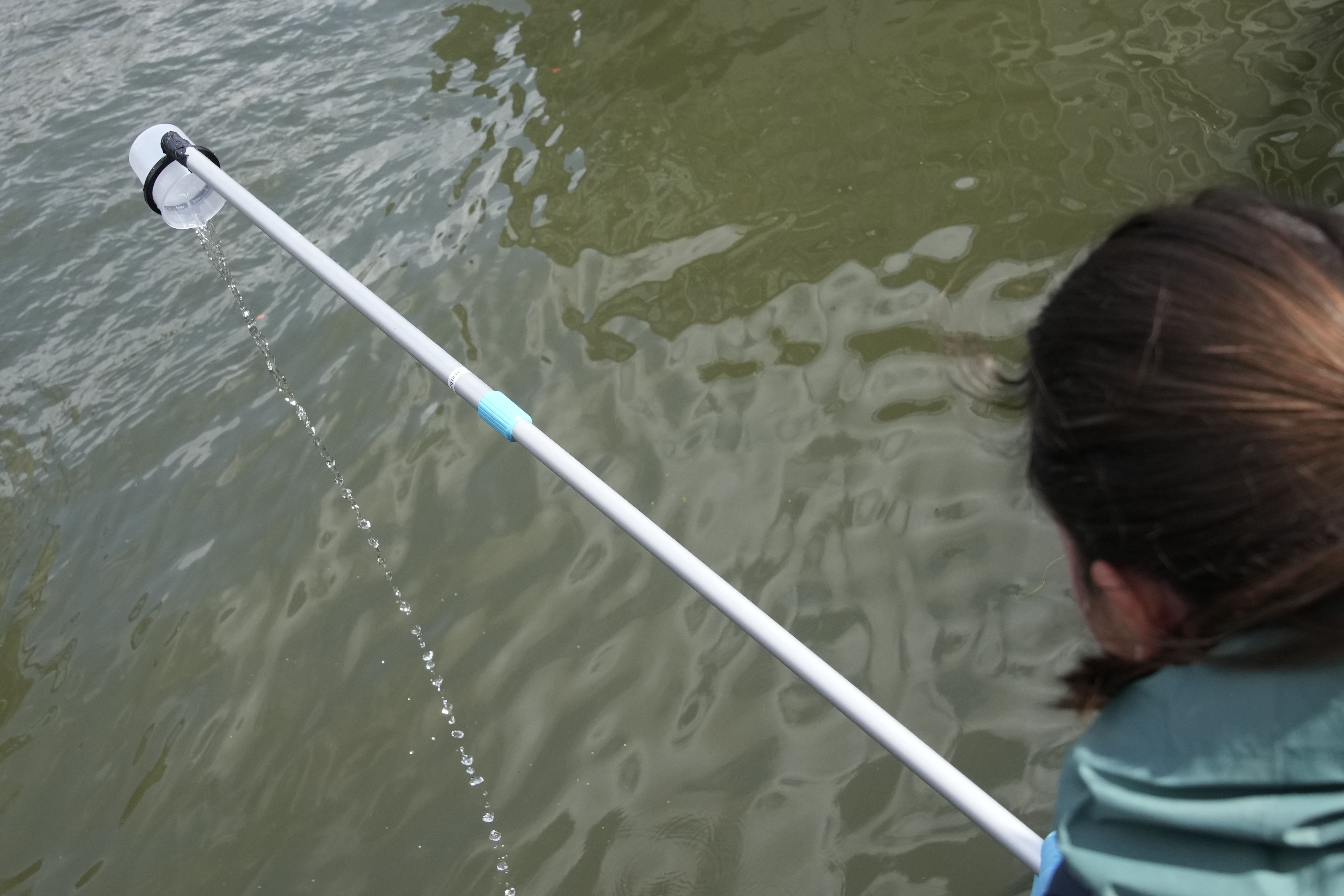 Maelys Hemon takes samples of water of the Seine River before a quality test Aug. 4 in Paris. Heavy rains have set back plans to test Paris’ readiness for swimmers to race in the River Seine at next year’s Summer Olympics.