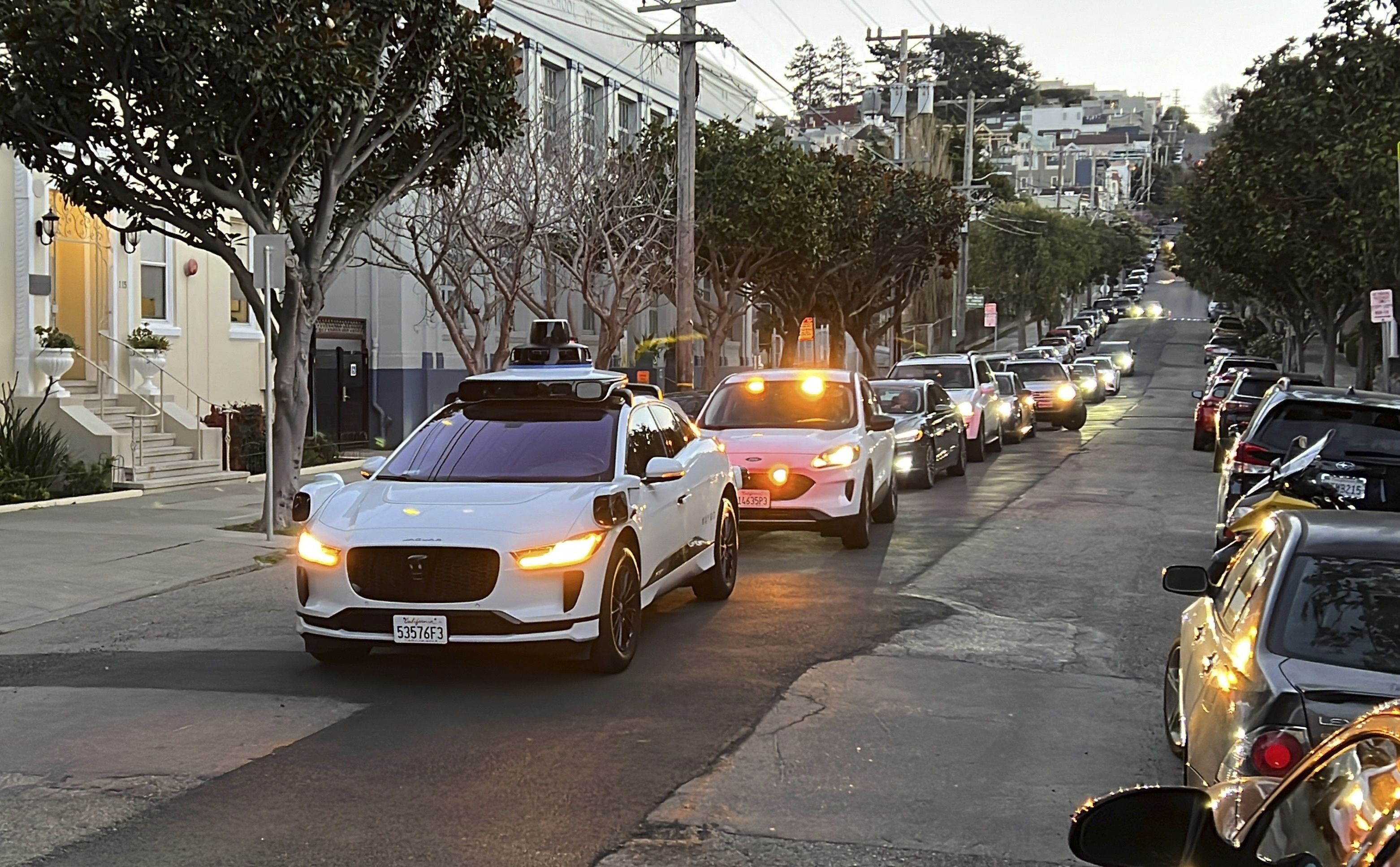 A Waymo driverless taxi stops on a street in San Francisco on Feb. 15. California regulators voted Thursday to allow two autonomous vehicle companies to operate driverless taxis 24 hours a day.