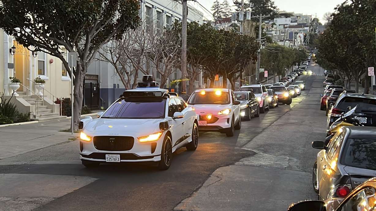 A Waymo driverless taxi stops on a street in San Francisco on Feb. 15. California regulators voted Thursday to allow two autonomous vehicle companies to operate driverless taxis 24 hours a day.