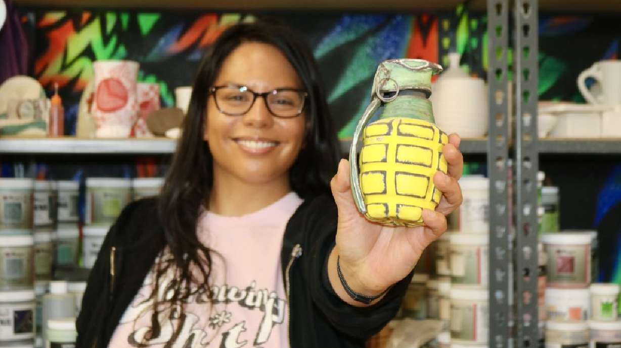 Sun Lotus Designs owner Marjorie Ann Eno shows off her pottery at the Tilted Kiln in St. George on Aug. 2. From rocket ships to missiles and hand grenades, this pottery artist is blowing up the art scene in Washington County.