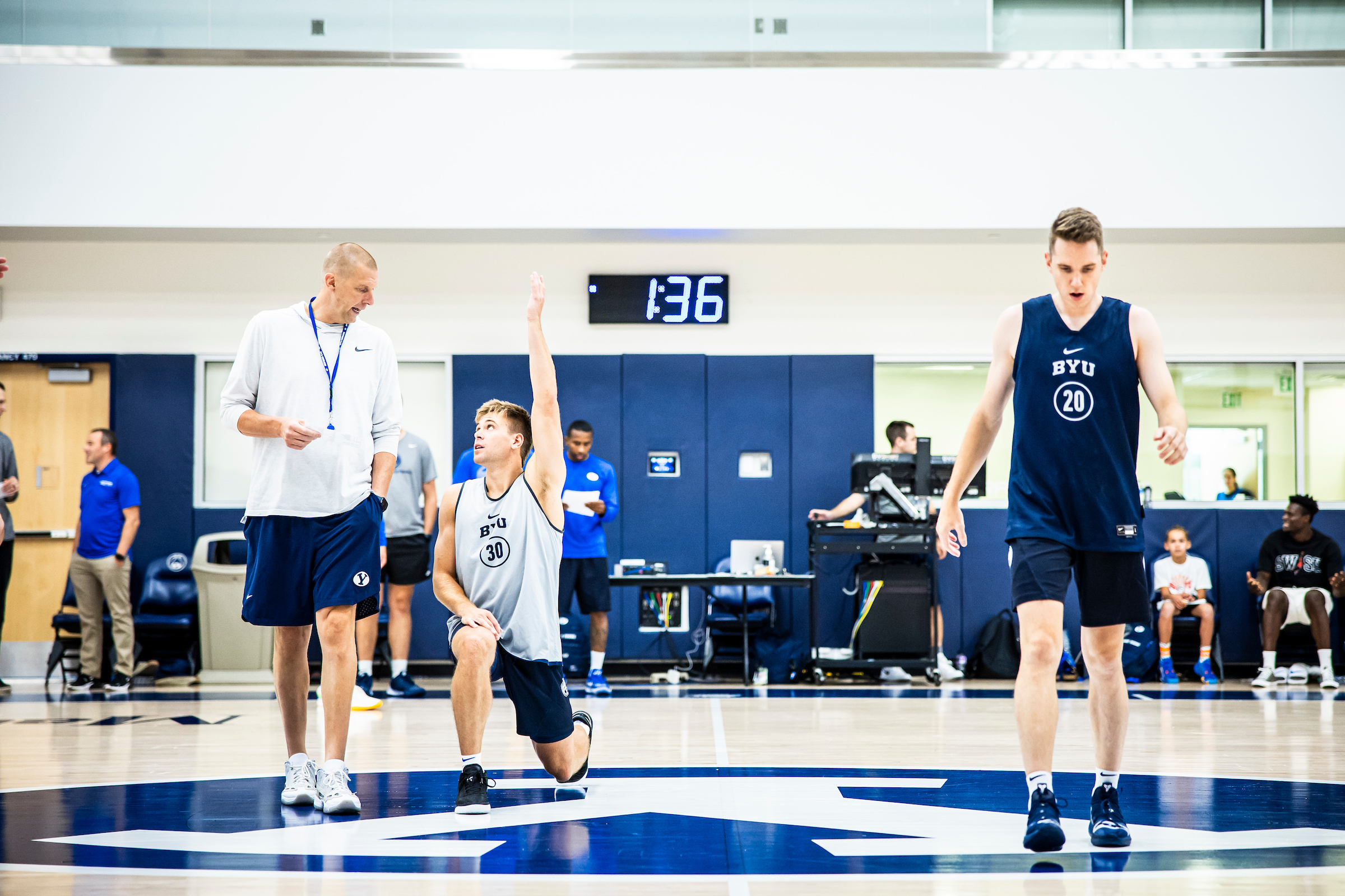 BYU men's basketball coach Mark Pope, far left, and guards Dallin Hall and Spencer Johnson warm up before practice, Friday, Aug. 11, 2023 at the Marriott Center Annex in Provo.