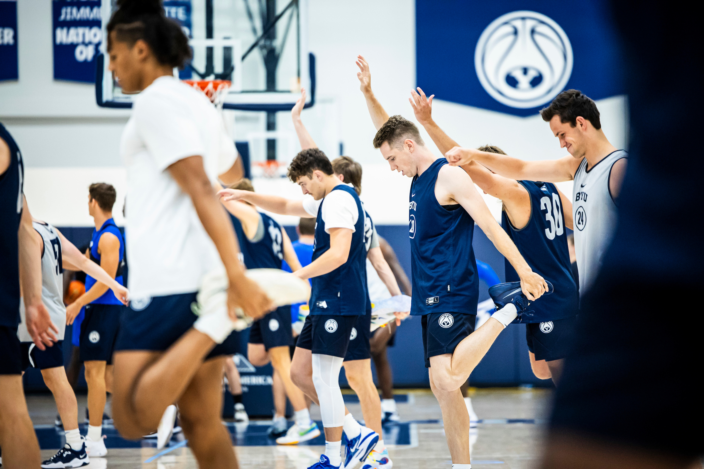 BYU basketball players stretch and warm up before practice, Friday, Aug. 11, 2023, in the Marriott Center Annex in Provo.