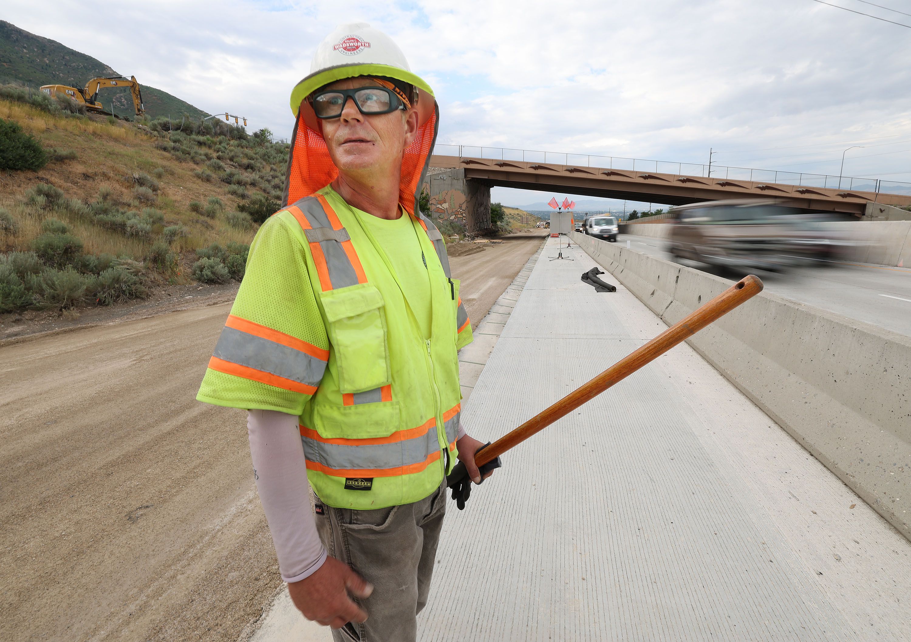 Steve Hardy works on I-215 in Millcreek on Aug. 1. The heat wave is extreme across much of the country.