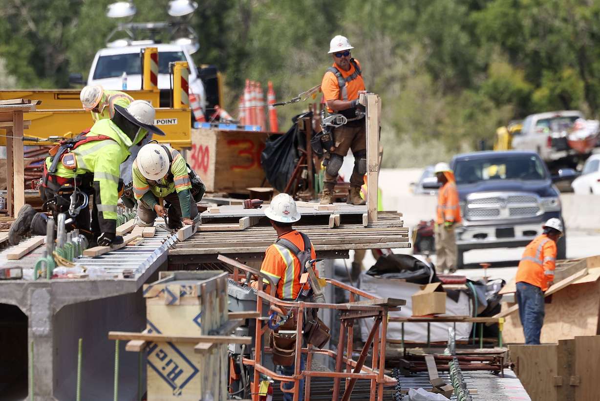 UDOT employees and subcontractors work on the I-80 Renewed reconstruction project in Salt Lake City on Friday.