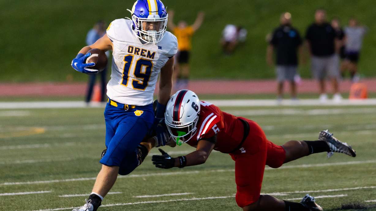 Orem’s Mack Hixson runs the ball at the high school football season opener against East at East High School in Salt Lake City on Friday, Aug. 11, 2023.