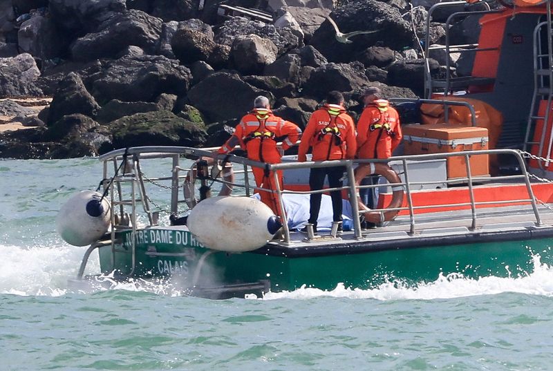 A lifeboat enters the port of Calais following a rescue operation after a migrant boat trying to cross the Channel from France capsized, in Calais, France, on Saturday.