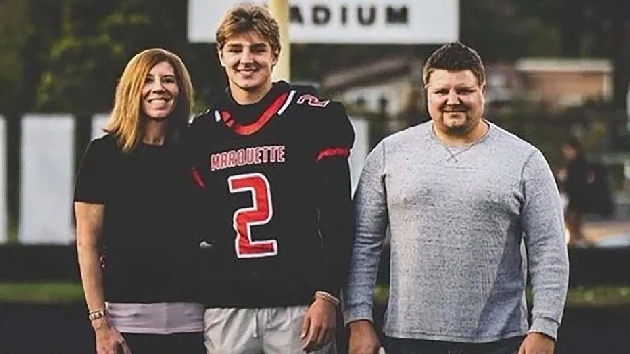 Jordan DeMay poses with his parents.