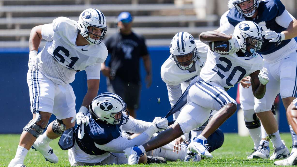 BYU running back Deion Smith looks for extra yardage during a scrimmage, Saturday, Aug. 12, 2023, at LaVell Edwards Stadium in Provo.