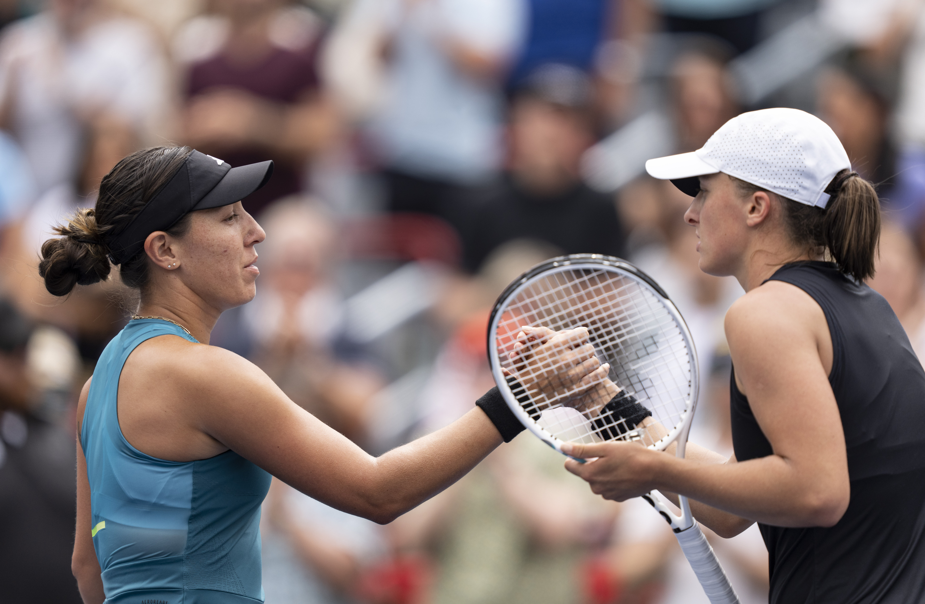 Jessica Pegula of the United States, left, shakes hands with Iga Swiatek of Poland, following the semifinals of the National Bank Open women’s tennis tournament Saturday, Aug. 12, 2023, in Montreal.