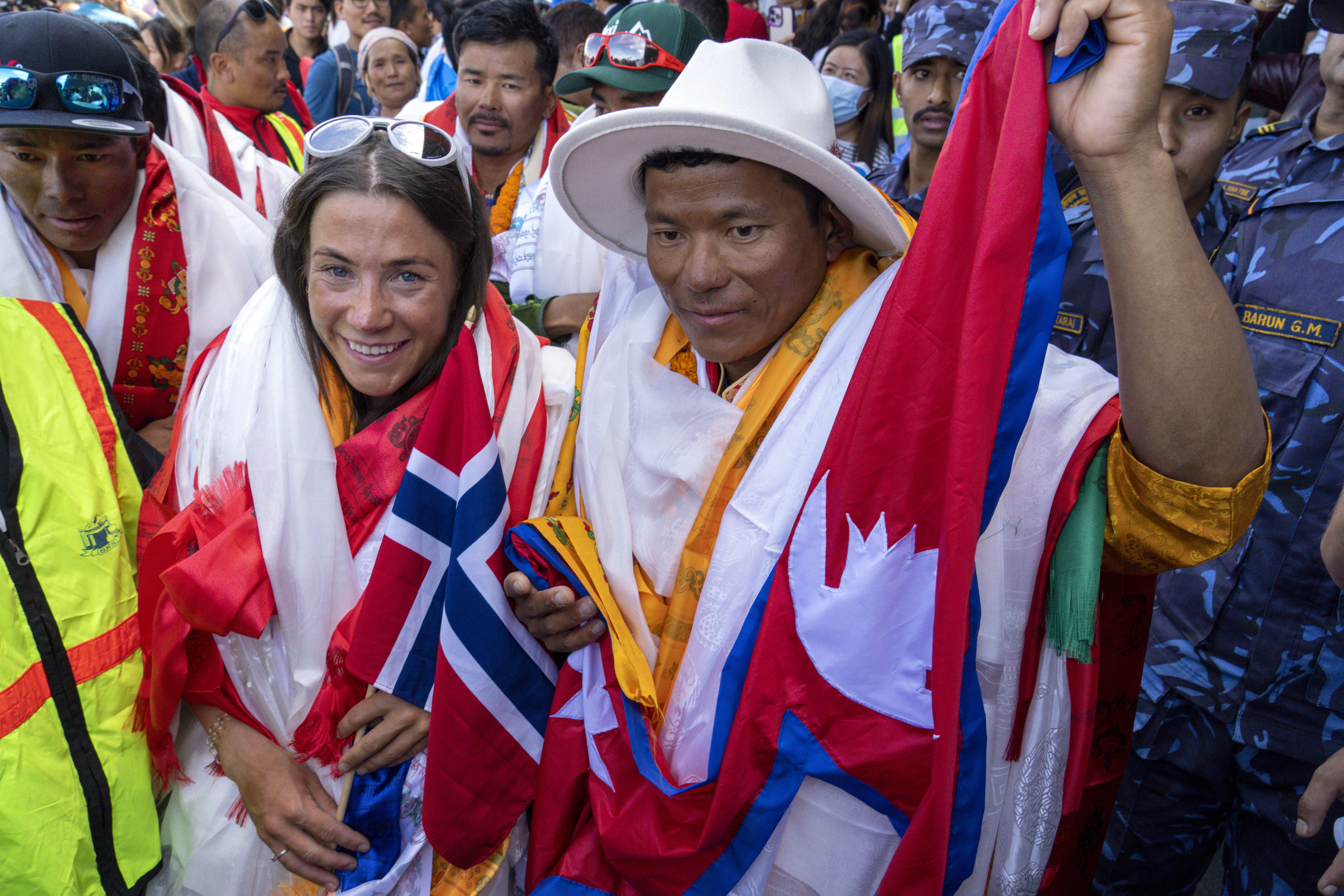 FILE - Norwegian climber Kristin Harila, left, and her Nepali sherpa guide Tenjen Sherpa, right, who climbed the world's 14 tallest mountains in record time, arrive in Kathmandu, Nepal, Saturday, Aug. 5, 2023. A Pakistani mountaineer said Saturday, Aug. 12, 2023, that an investigation has been launched into the death of a Pakistani porter during Harila's record quest. 