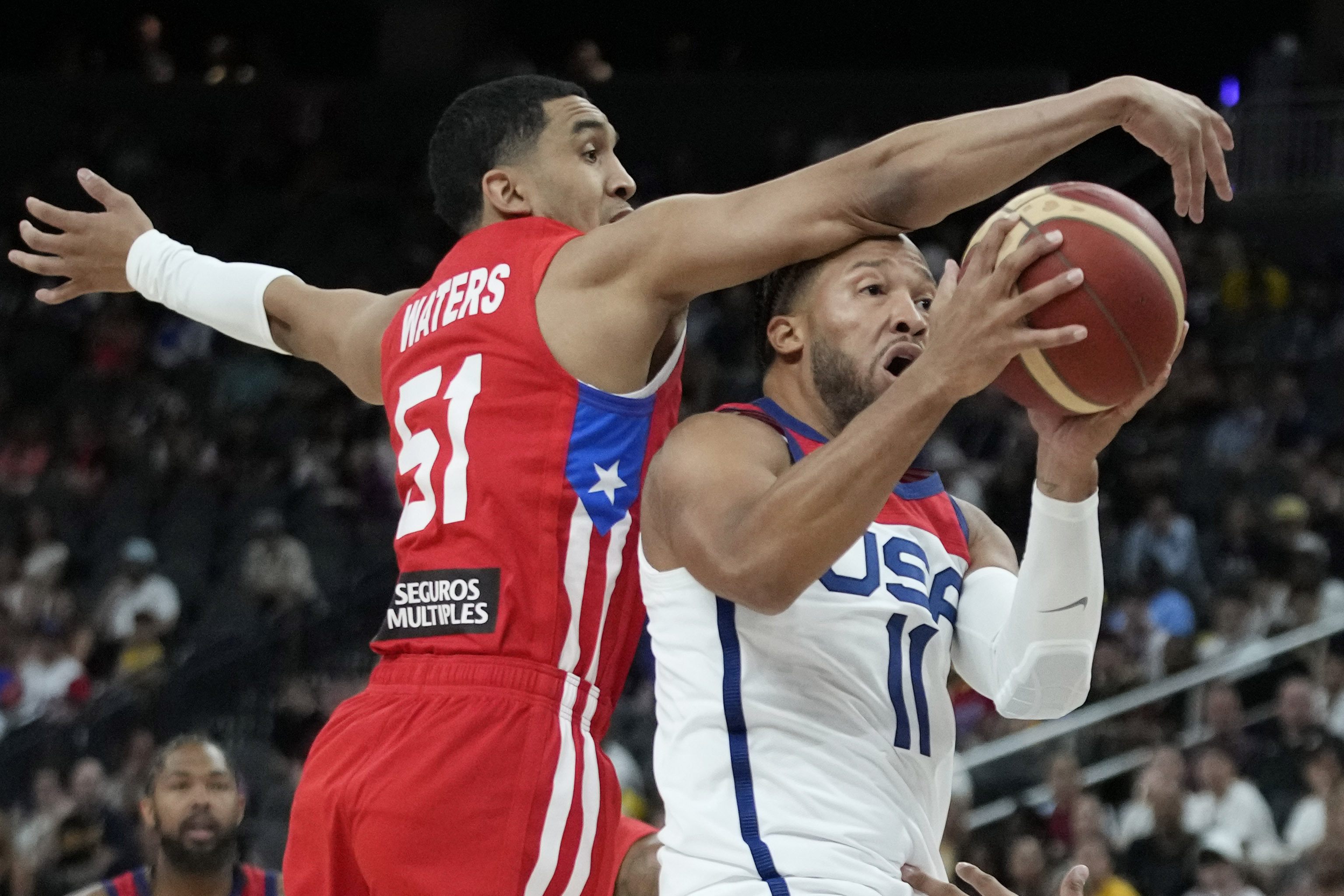 United States' Jalen Brunson, right, attempts to shoot around Puerto Rico's Tremont Waters during the first half of an exhibition basketball game Monday, Aug. 7, 2023, in Las Vegas. 