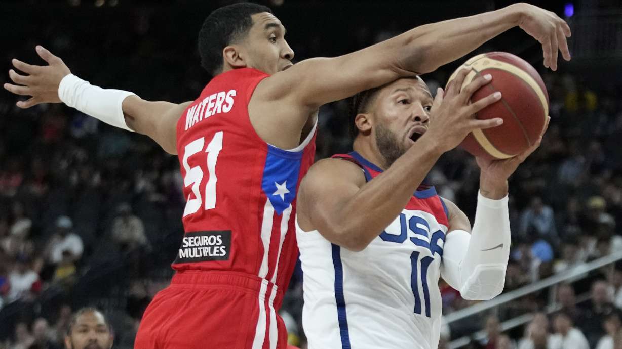 United States' Jalen Brunson, right, attempts to shoot around Puerto Rico's Tremont Waters during the first half of an exhibition basketball game Monday, Aug. 7, 2023, in Las Vegas.