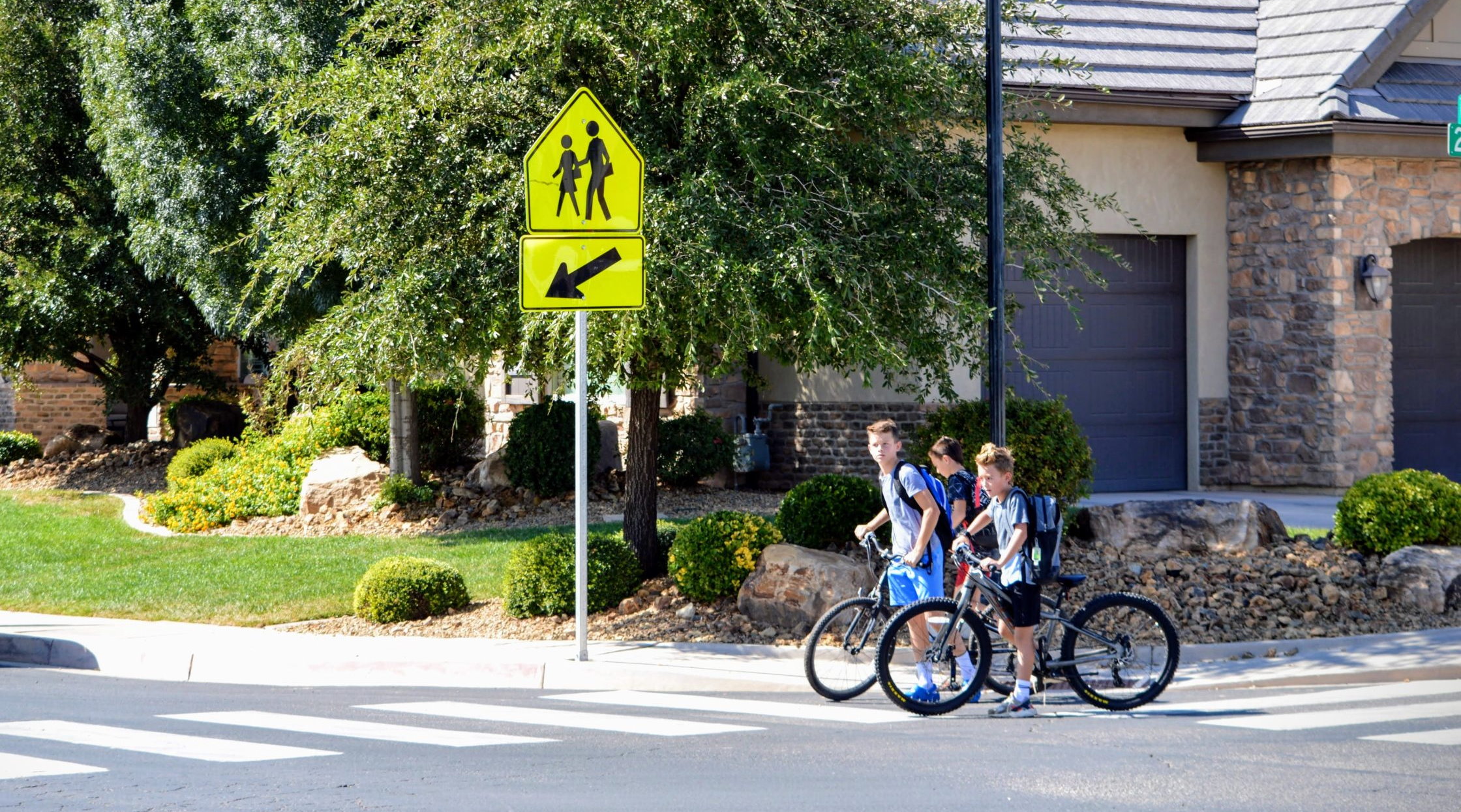 Students with bikes stop at a crosswalk in St. George, Sept. 15, 2022. The new school year renews the need for pedestrians and motorists to pay attention to who is on the road. 