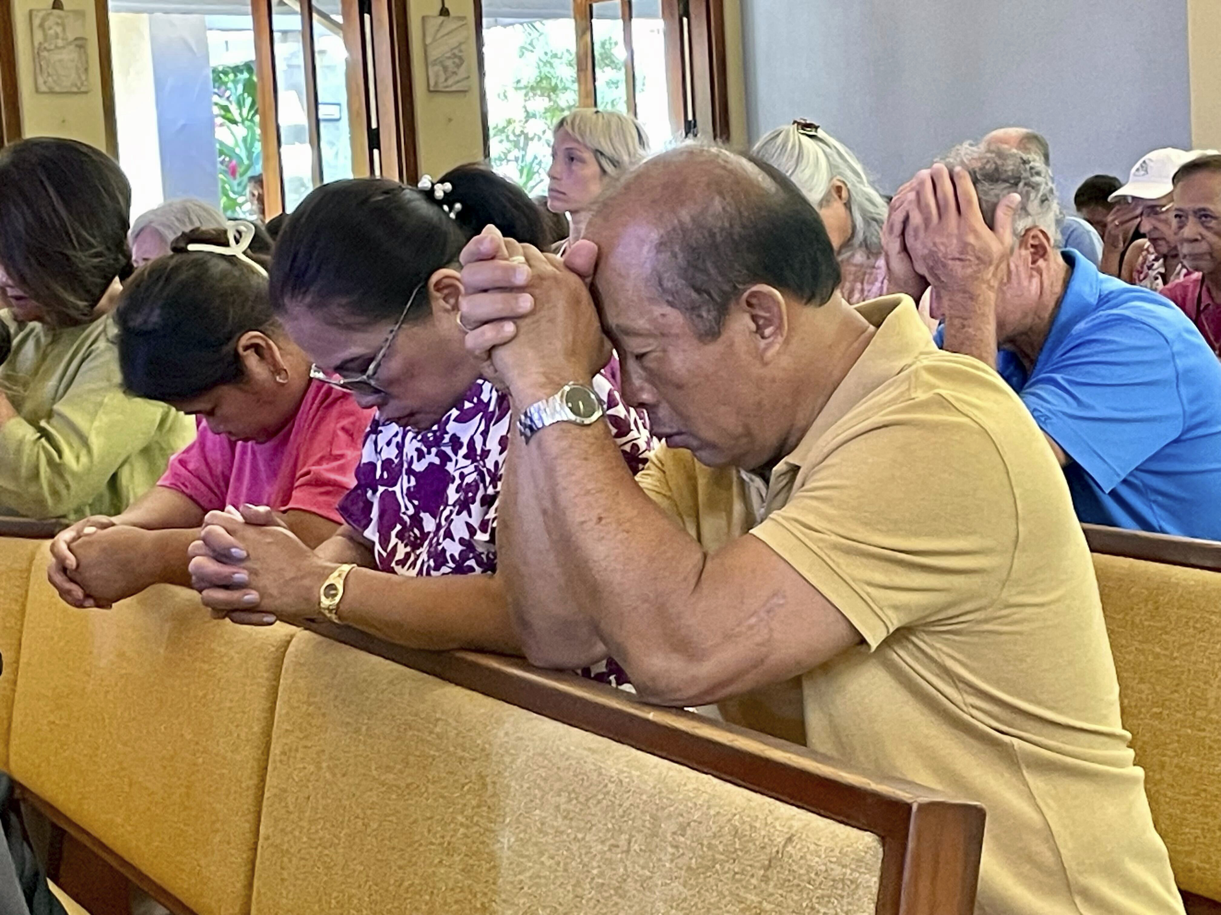 Parishioners attend Mass at Sacred Hearts Mission Church in Kapalua, Hawaii, Sunday. Sacred Hearts Mission Church hosted congregants from Maria Lanakila Catholic Church in Lahaina, including several people who lost family members in fires that burned most of the Maui town days earlier.
