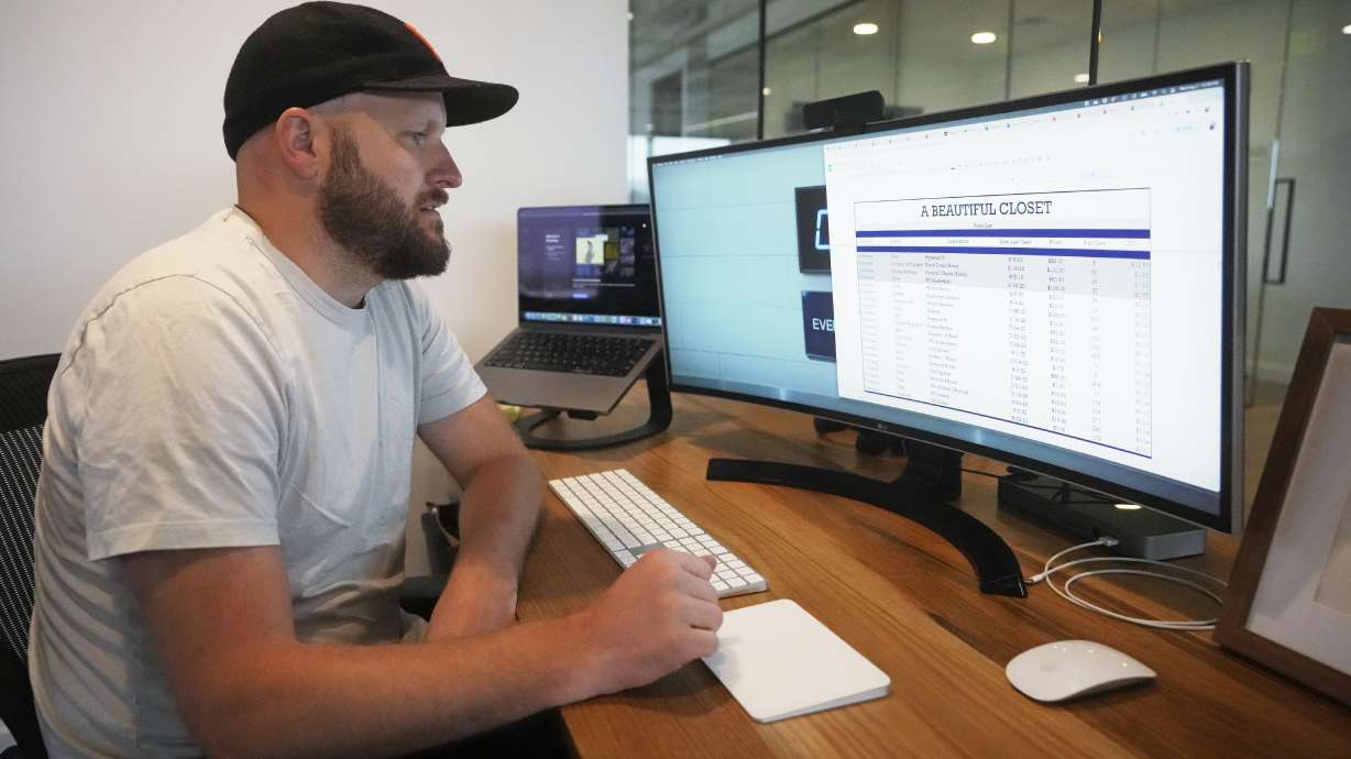 Jake Welch looks at a spreadsheet on his computer Aug. 2, in Salt Lake City. The 36-year-old brand director for an advertising firm calculates the cost-per-wear of his wardrobe by highlighting 200 items in a spreadsheet and meticulously listing the price he paid for each of them as well as how many times he's worn it.