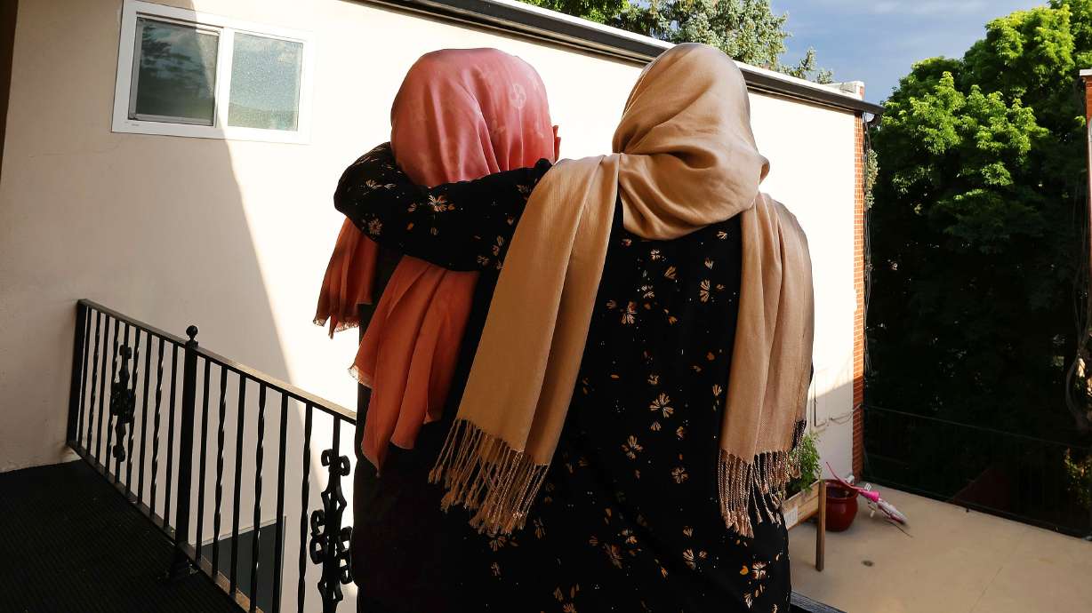 Two Afghan sisters, ages 32 and 17, hug at their apartment in Salt Lake City on July 27. Their identities are not shown because of concerns they could be identified by the Taliban.