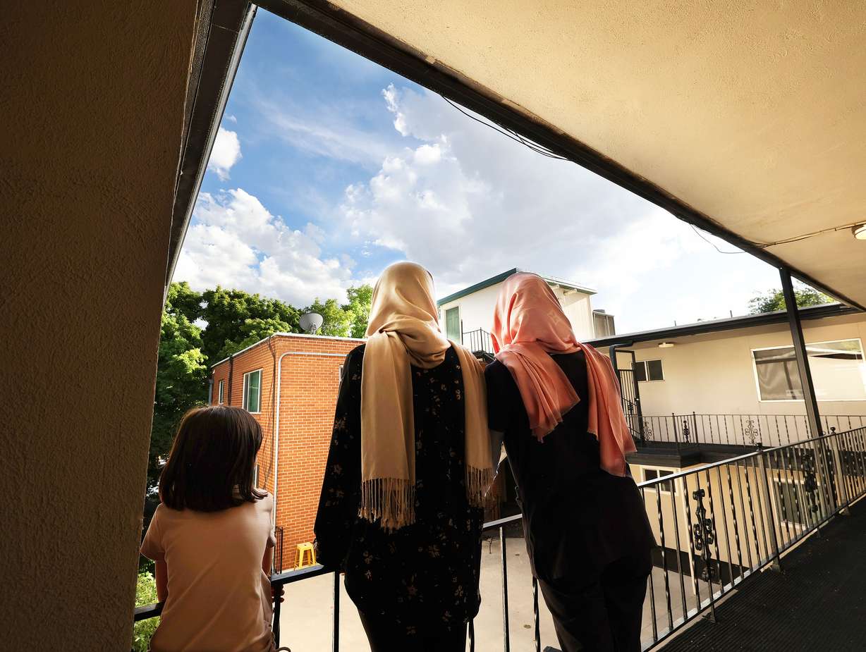 Two Afghan sisters, ages 32 and 17, stand with their 6-year-old niece at their apartment in Salt Lake City on July 27. Their identities are not shown to help protect them from the Taliban.