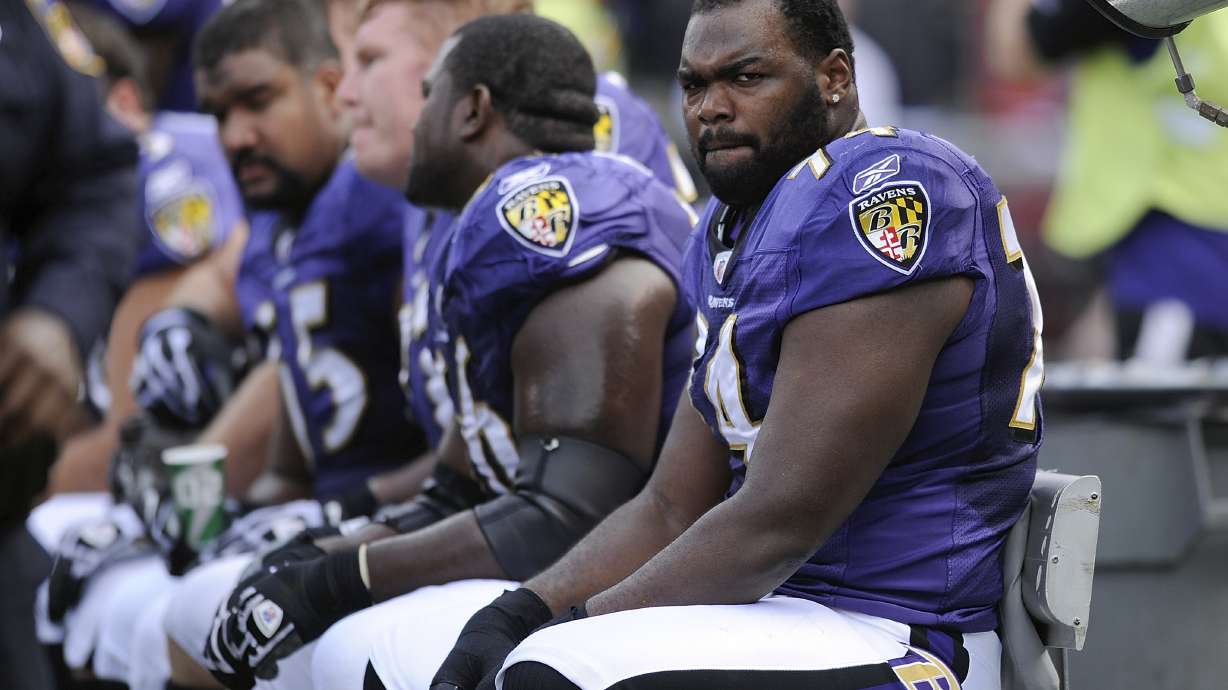 FILE - Baltimore Ravens offensive tackle Michael Oher sits on the beach during the first half of an NFL football game against the Buffalo Bills in Baltimore, Sunday, Oct. 24, 2010. Michael Oher, the former NFL tackle known for the movie “The Blind Side,” filed a petition Monday in a Tennessee probate court accusing Sean and Leigh Anne Tuohy of lying to him by having him sign papers making them his conservators rather than his adoptive parents nearly two decades ago.