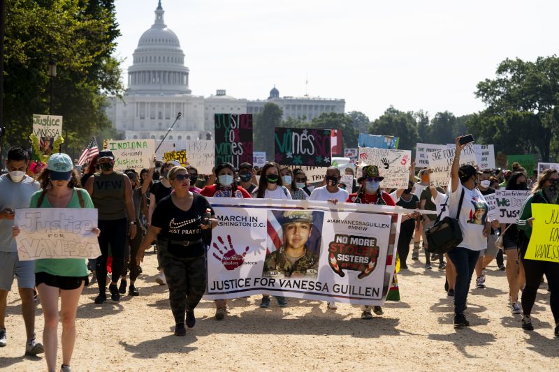 Supporters of the family of slain Army Spc. Vanessa Guillén march to the White House along the National Mall as Capitol Hill is seen in the distance after a news conference in Washington, July 30, 2020. A federal judge has sentenced a Texas woman Monday to 30 years in prison for helping to dispose of the body of U.S. soldier Guillén.
