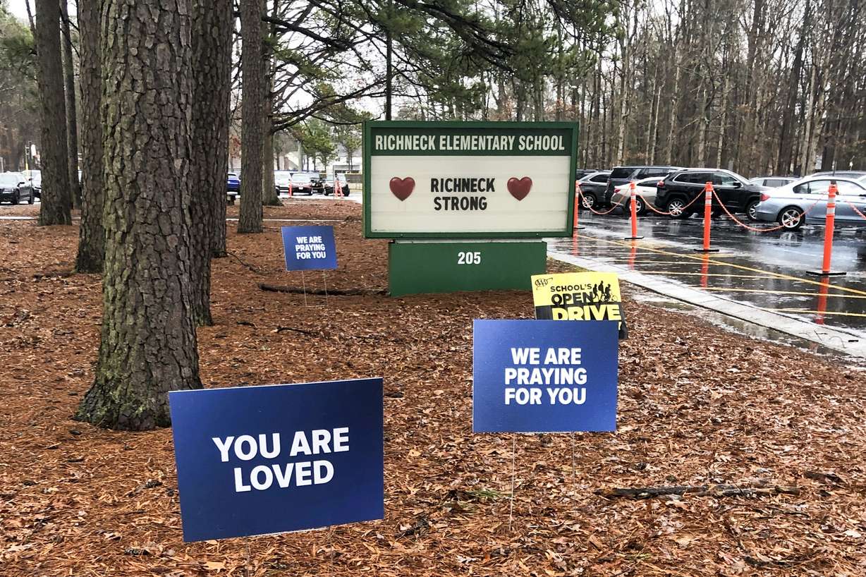 Signs stand outside Richneck Elementary School in Newport News, Va., on Jan. 25.