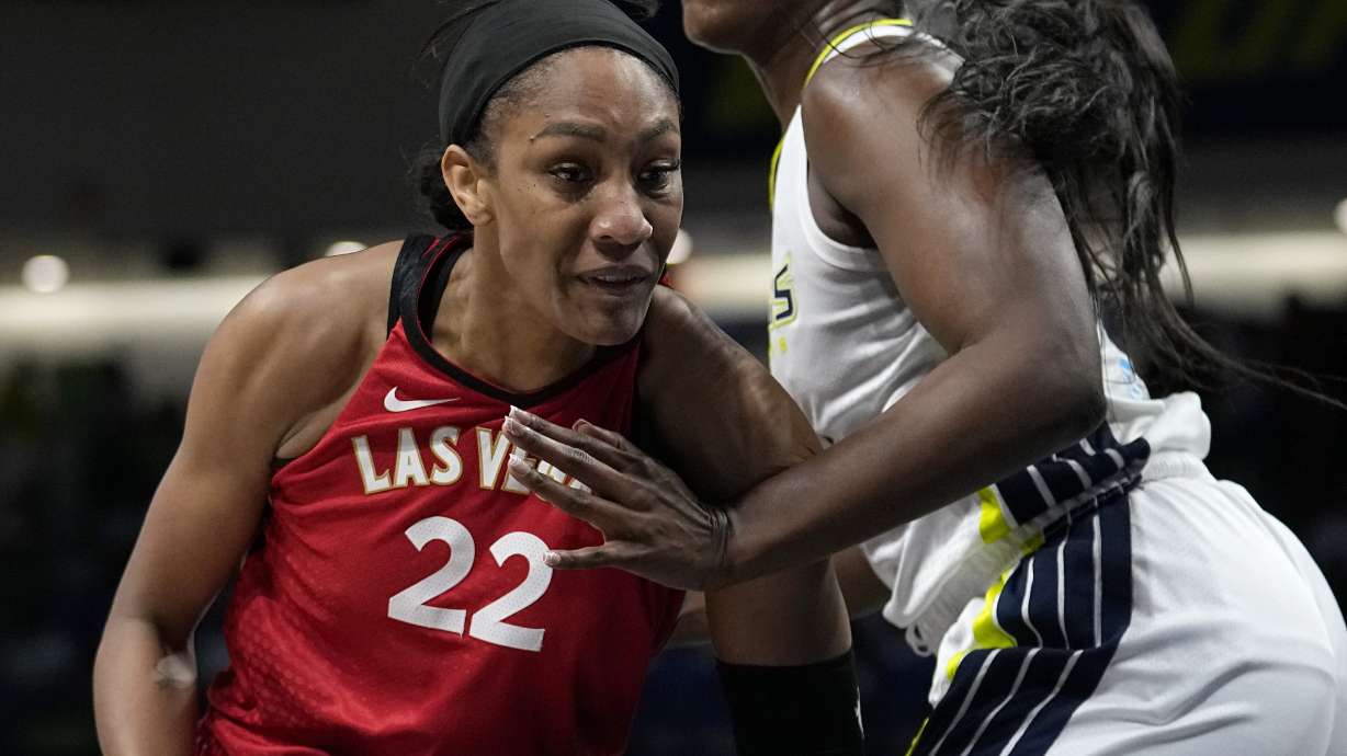 Las Vegas Aces forward A'ja Wilson (22) works for a shot as Dallas Wings' Kalani Brown, right, defends in the first half of a WNBA basketball game, Tuesday, Aug. 8, 2023, in Arlington, Texas.