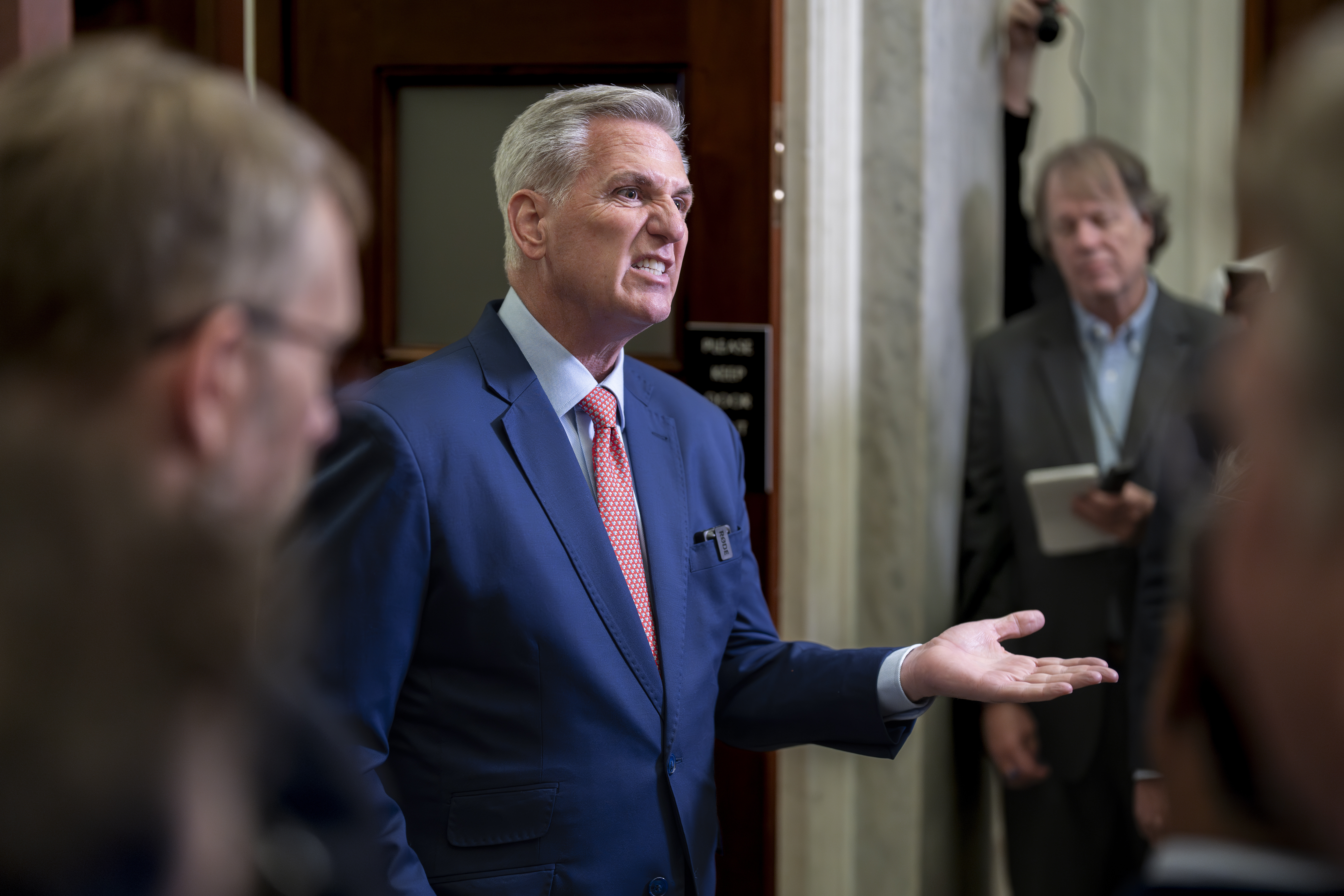 Speaker of the House Kevin McCarthy, R-Calif., talks to at the Capitol in Washington, July 25. Congressional leaders are pitching a stopgap government funding package to avoid a federal shutdown after next month.
