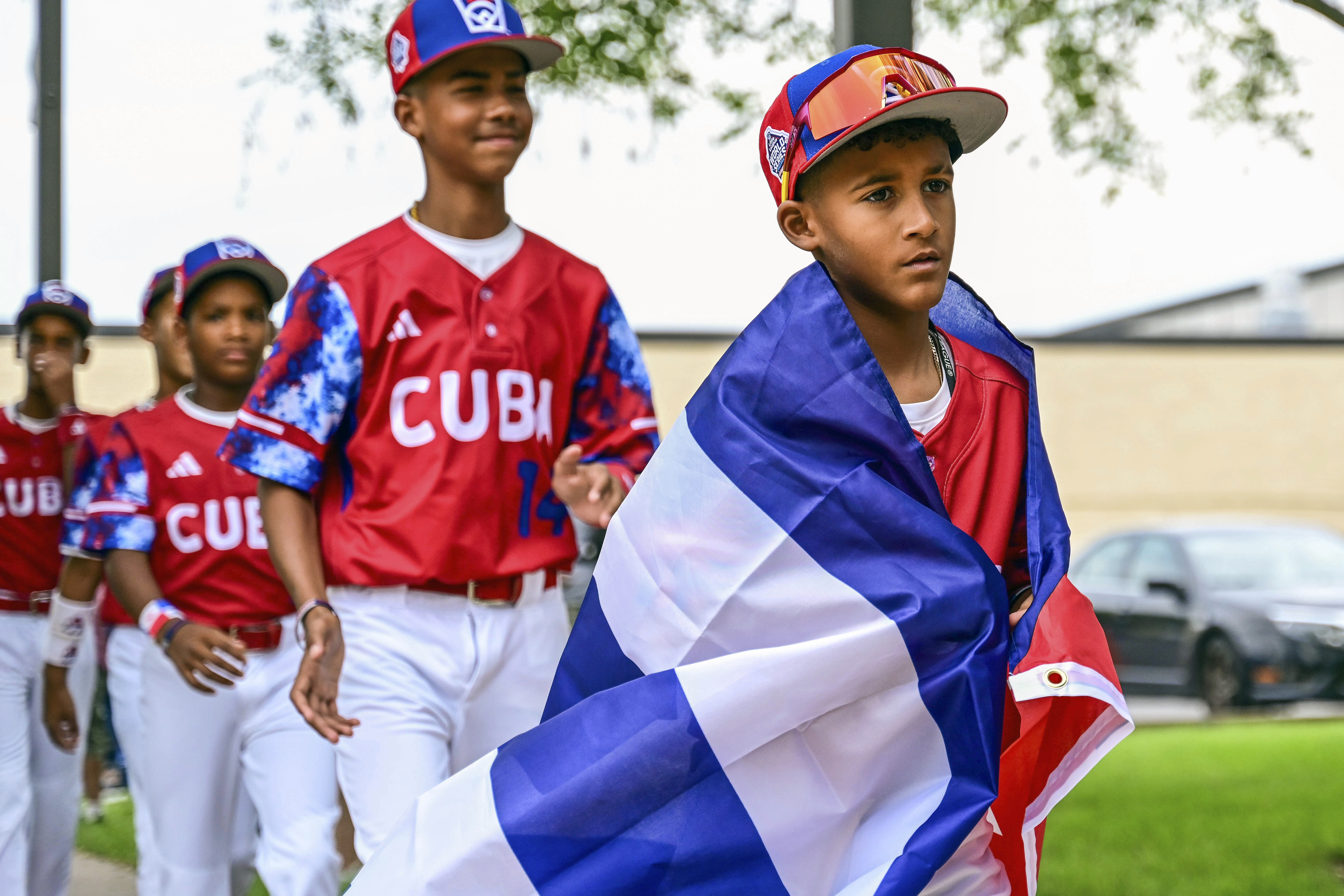 This photo provided by Caleb Craig shows Alfredo Despaigne leading his Cuban teammates as they arrive at Penn College for the Little League World Series picnic in Williamsport, Pa., Monday, Aug. 14, 2023. They’ve been hosting a Little League World Series around here since 1947, but they’ll be welcoming a new guest when the tournament starts Wednesday – Cuba.