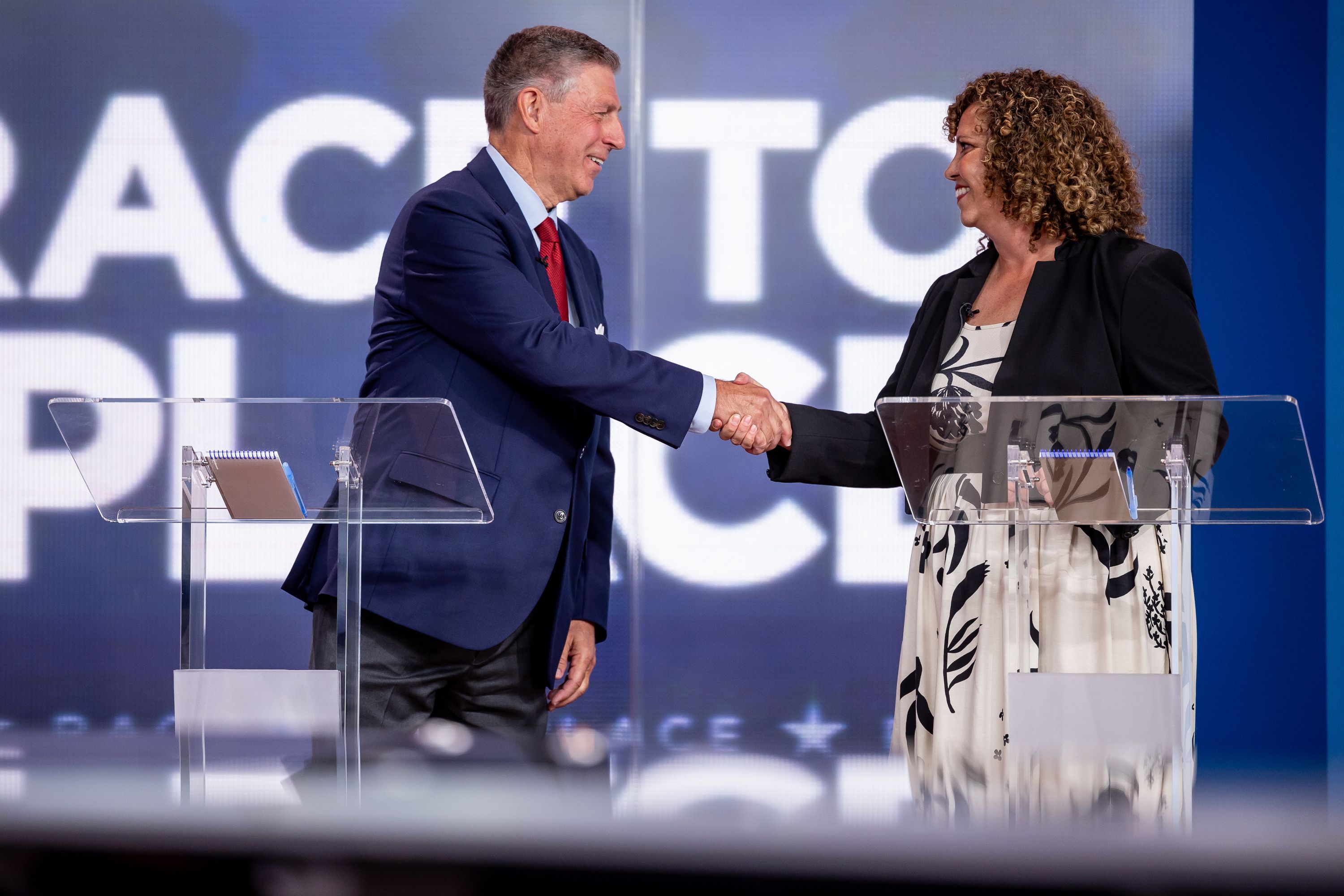 Bruce Hough and Celeste Maloy shake hands at the conclusion of a televised debate at KSL-TV in Salt Lake City on Tuesday. The two are running in the GOP primary to replace Rep. Chris Stewart in Utah’s 2nd Congressional District.