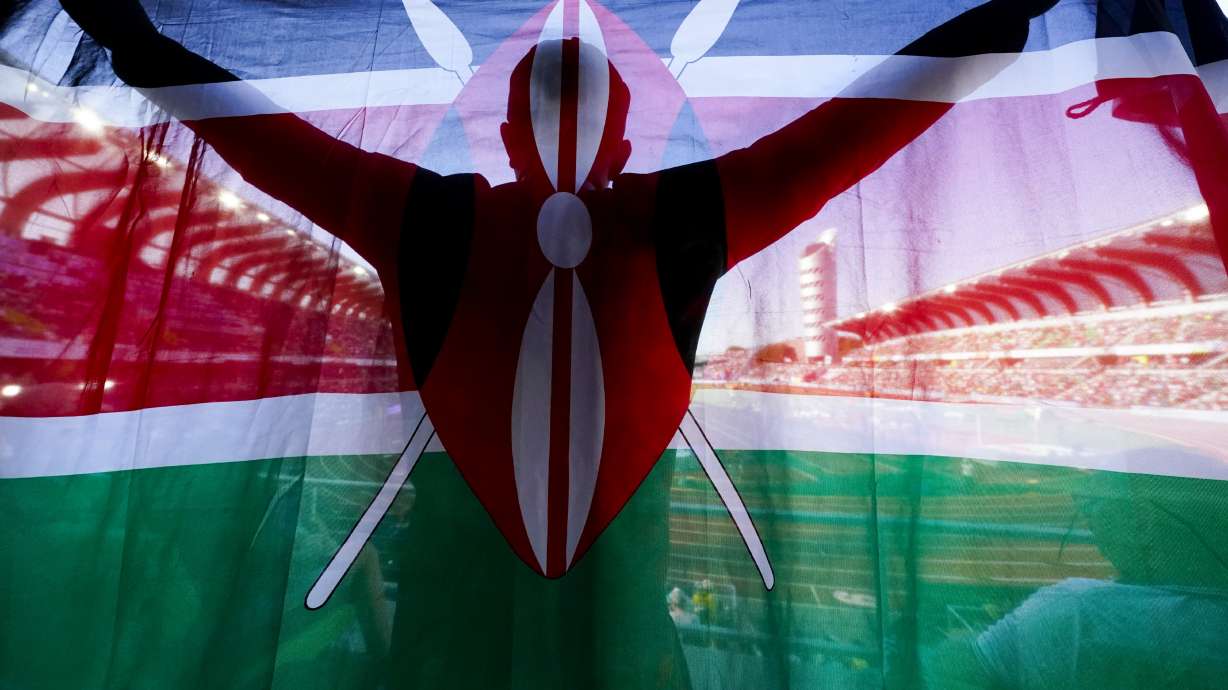 FILE - A fan of Kenya holds up a national flag during the final in the women's 5000-meter run at the World Athletics Championships on July 23, 2022, in Eugene, Ore. Kenya has achieved unparalleled success in modern distance running, but a wave of positive drug tests over the last decade has ruined that reputation, made it the sport's latest doping pariah, and pushed it to the brink of a sweeping international ban that would sit it alongside Russia.