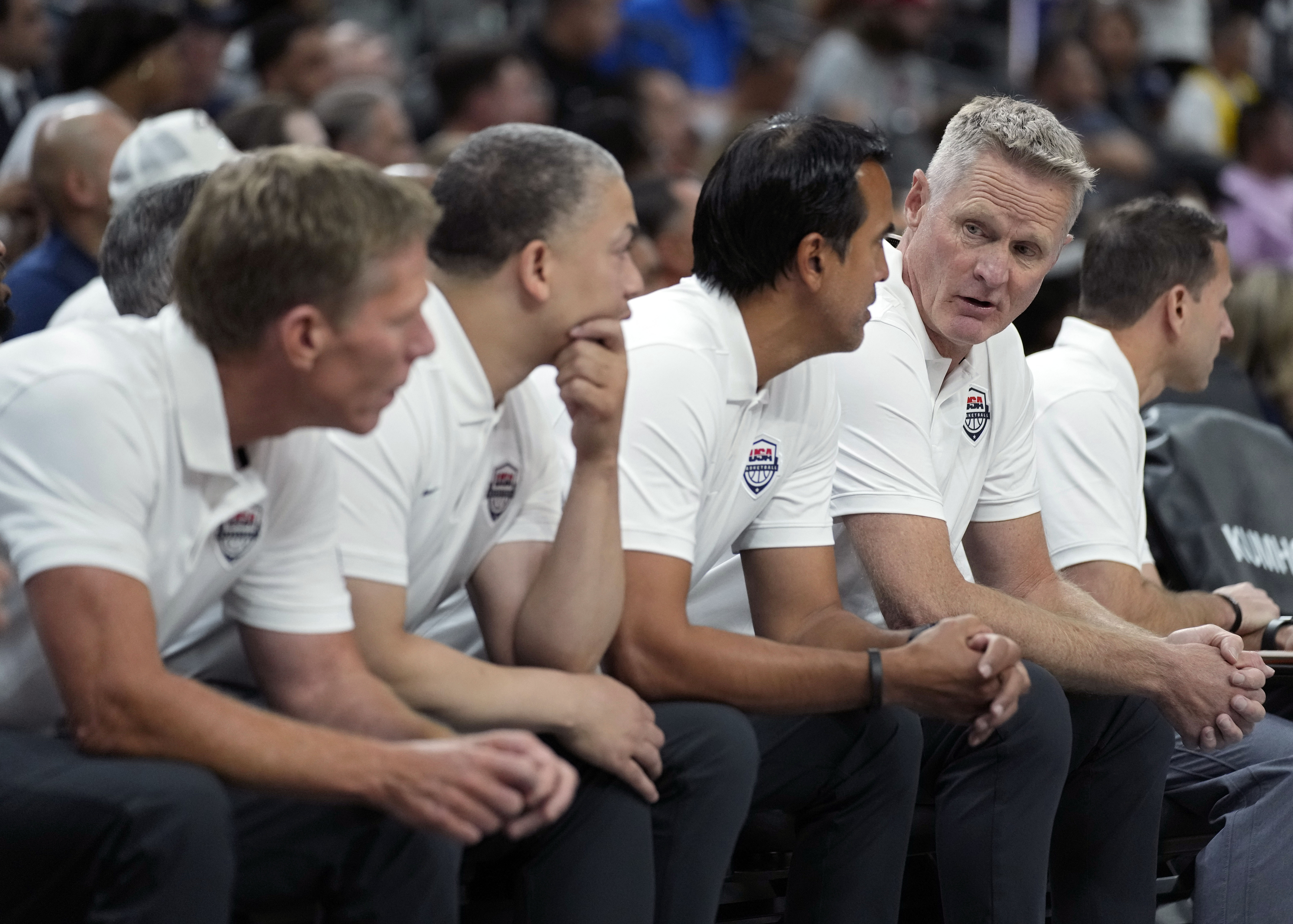 United States head coach Steve Kerr, fourth from left, speaks with assistant coach Erik Spoelstra, third from left, during the first half of an exhibition basketball game against Puerto Rico, Monday, Aug. 7, 2023, in Las Vegas. 