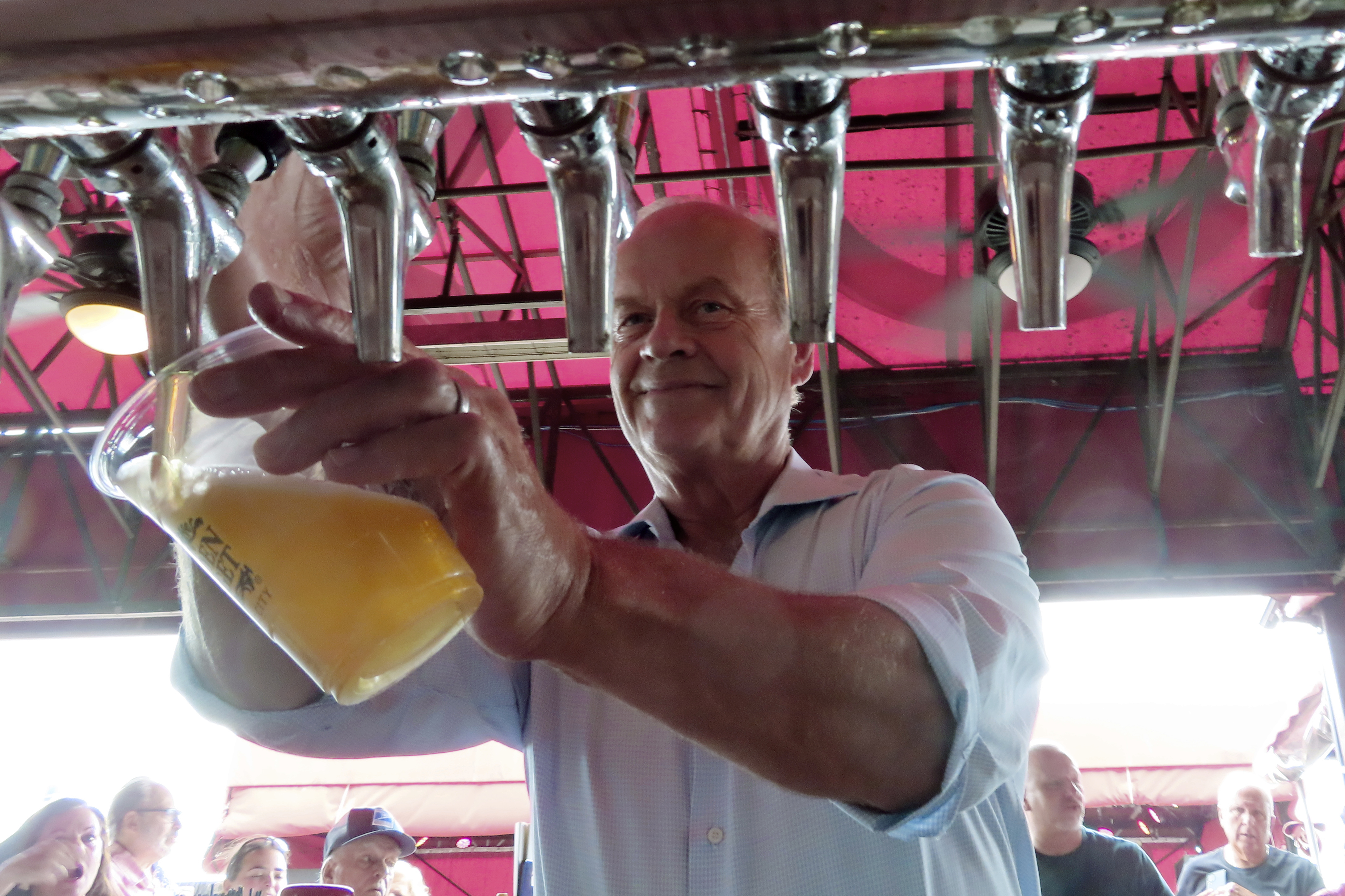Actor Kelsey Grammer pours beers during a guest bartending stint at the Golden Nugget casino in Atlantic City, N.J. on July 14, 2023. Atlantic City's casinos won 3% less from in-person gamblers in July as they did a year earlier, although total gambling revenue, including internet and sports betting at casinos and horse tracks, rose by 5.3%. 