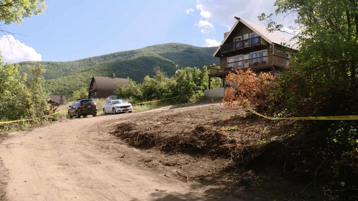 Police tape drapes the property around a Wasatch County cabin Aug. 8, a day after police say a father was forced to shoot his adult son in self-defense after being stabbed multiple times.