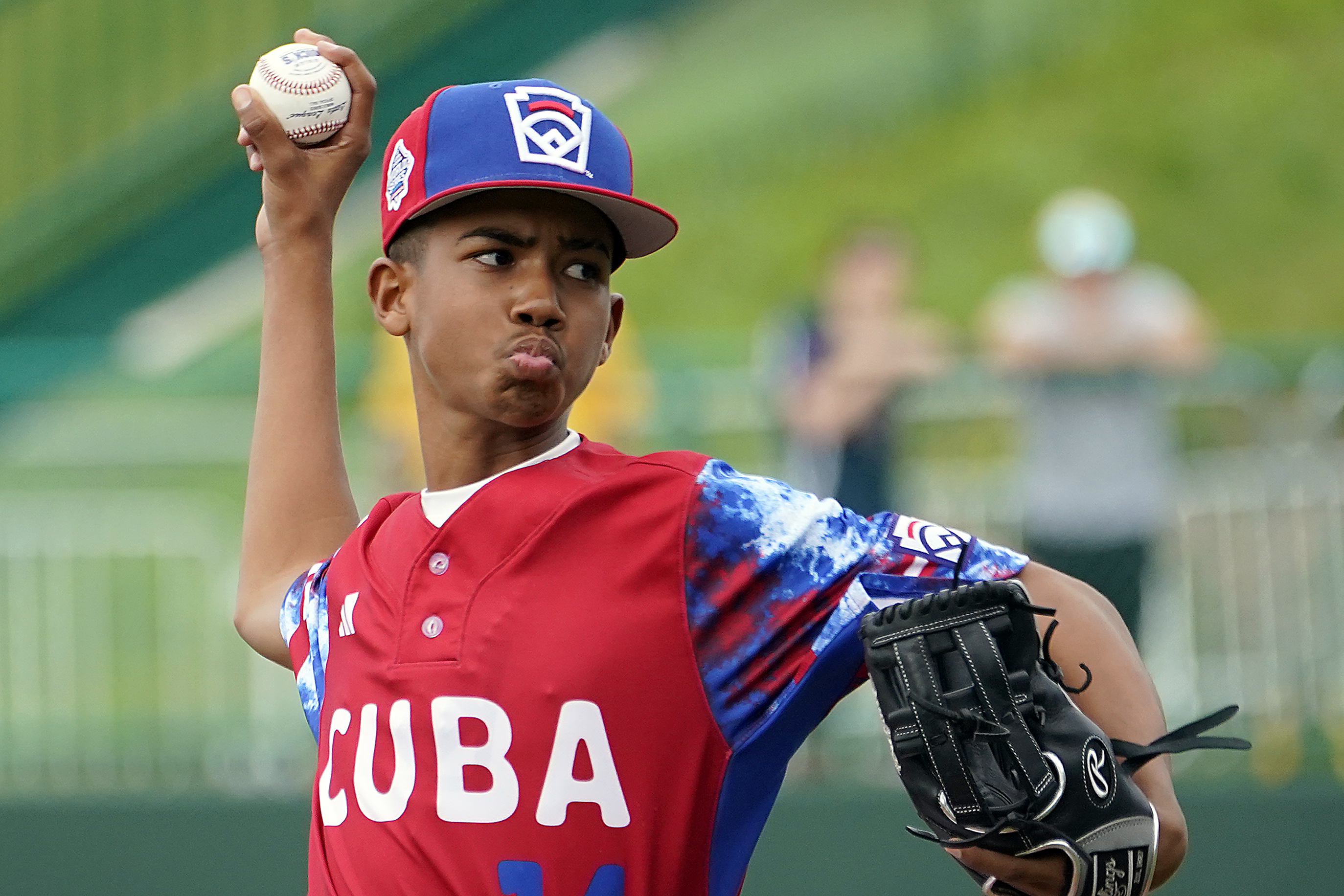 Cuba starting pitcher Luis Gurriel (14) throws to a Japan batter during the first inning of a baseball game at the Little League World Series tournament in South Williamsport, Pa., Wednesday, Aug. 16, 2023. Japan won 1-0.