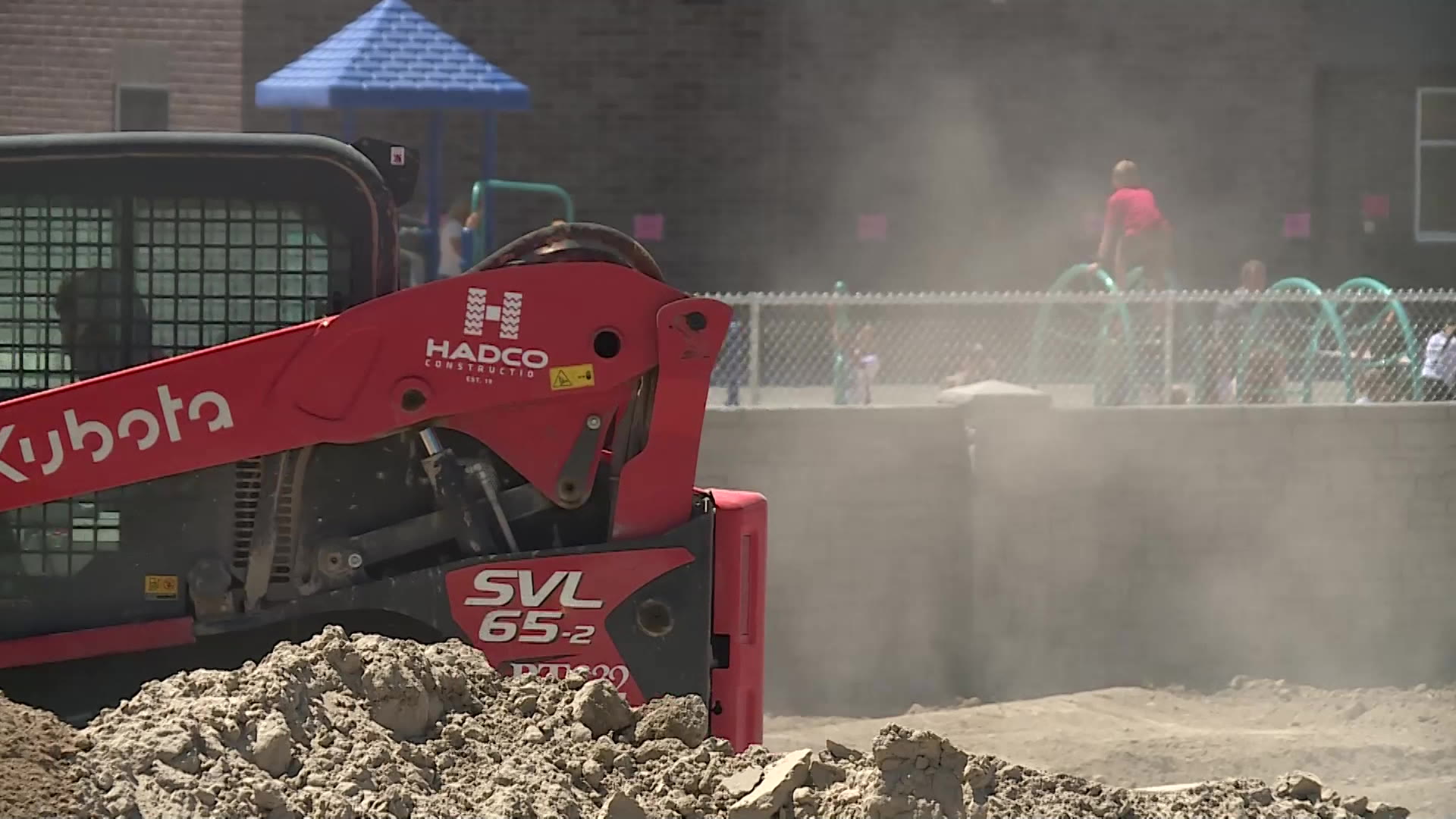 Construction workers are outside the school grounds as kids play. It was a race to the finish line to complete a new elementary school in the Overland community in time for the first day of class.