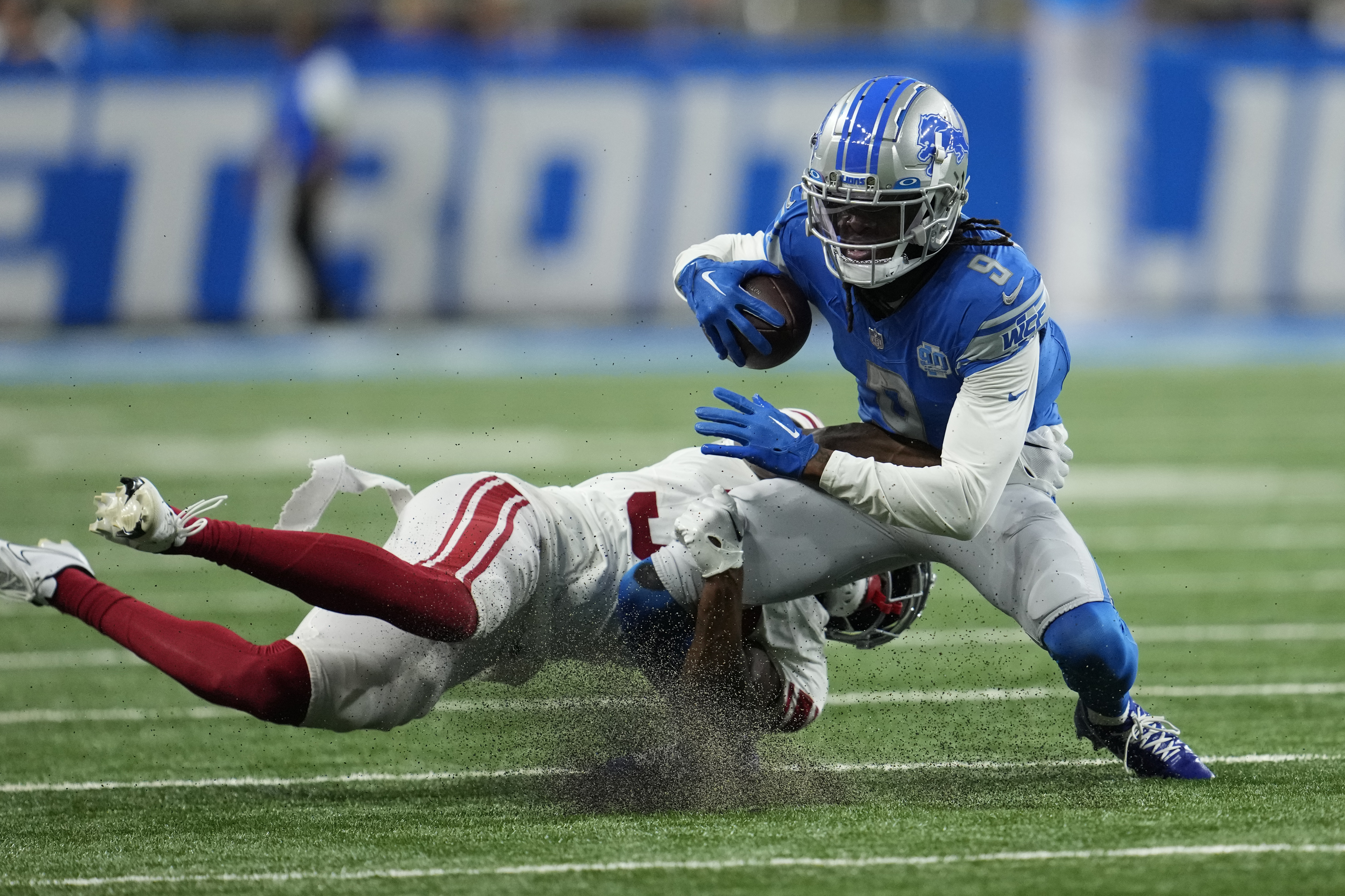 New York Giants cornerback Tre Hawkins III tackles Detroit Lions wide receiver Jameson Williams (9) during the first half of an NFL preseason football game, Friday, Aug. 11, 2023, in Detroit.
