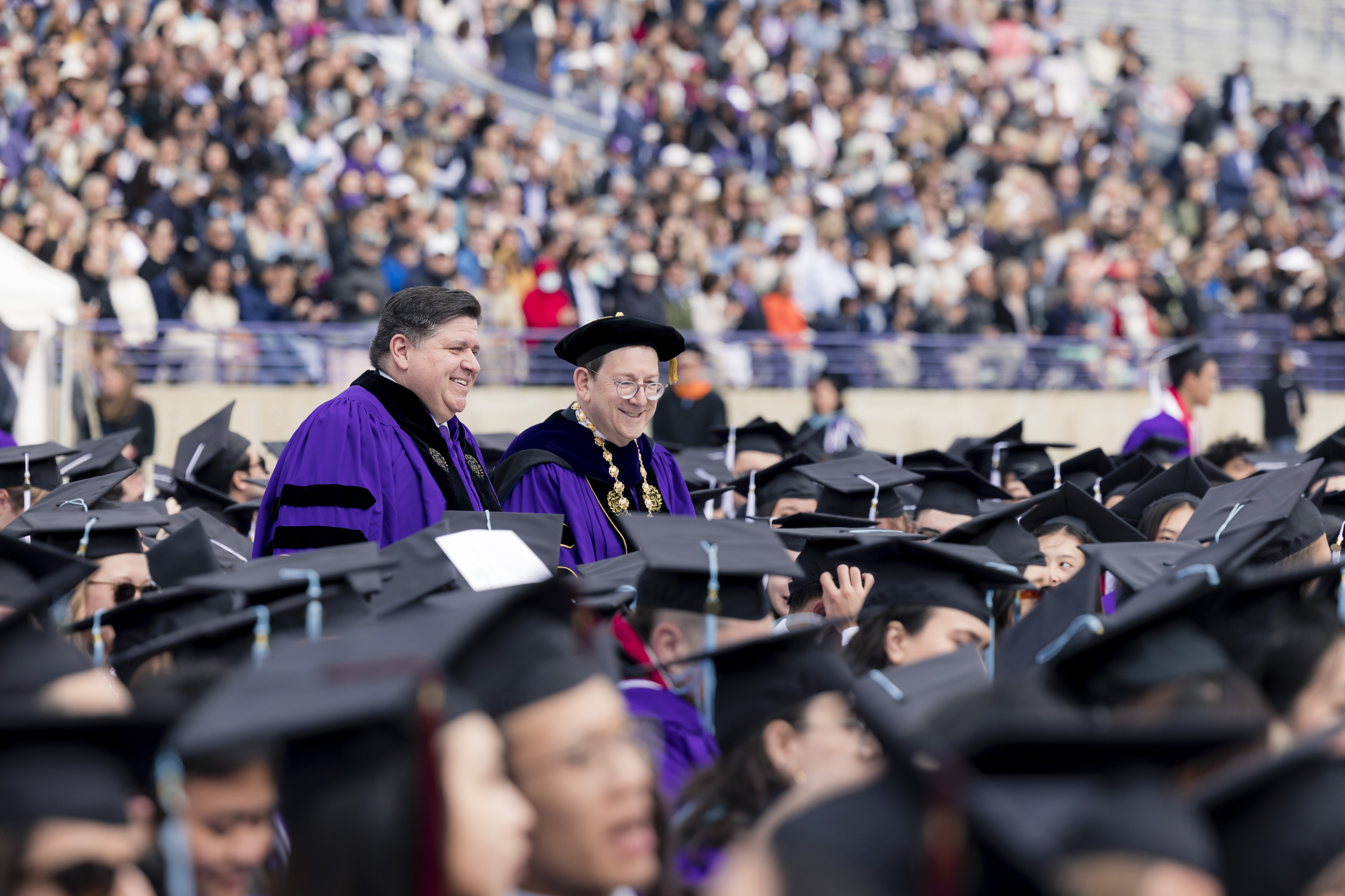 Gov. J.B. Pritzker walks alongside Michael H Schill, President of Northwestern, at the 156th annual commencement ceremony at Ryan Field Stadium at Northwestern University in Evanston, Ill., Monday, June 12, 2023. Gov. J.B. Pritzker received the Honorary Doctor of Laws for his work in the public sector. 