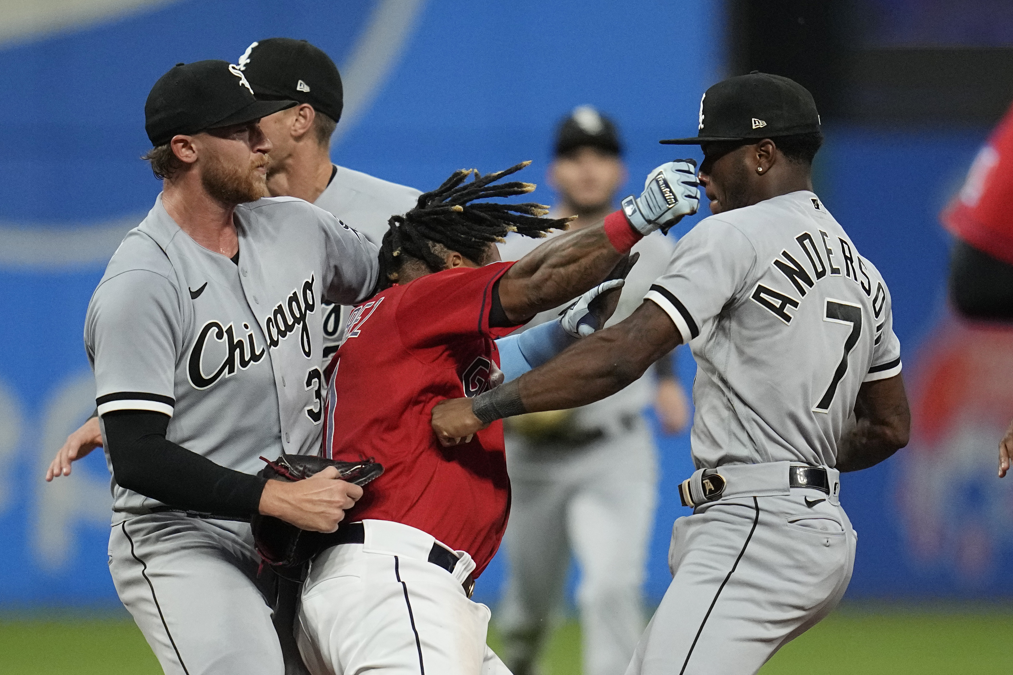 Cleveland Guardians' Jose Ramirez, center, and Chicago White Sox's Tim Anderson (7) exchange punches in the sixth inning of a baseball game Saturday, Aug. 5, 2023, in Cleveland. White Sox's Michael Kopech, left looks on. 