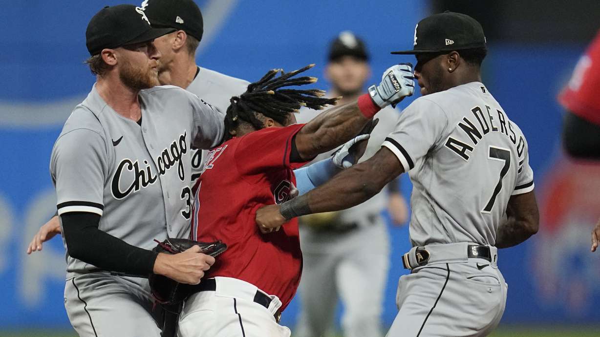 Cleveland Guardians' Jose Ramirez, center, and Chicago White Sox's Tim Anderson (7) exchange punches in the sixth inning of a baseball game Saturday, Aug. 5, 2023, in Cleveland. White Sox's Michael Kopech, left looks on.