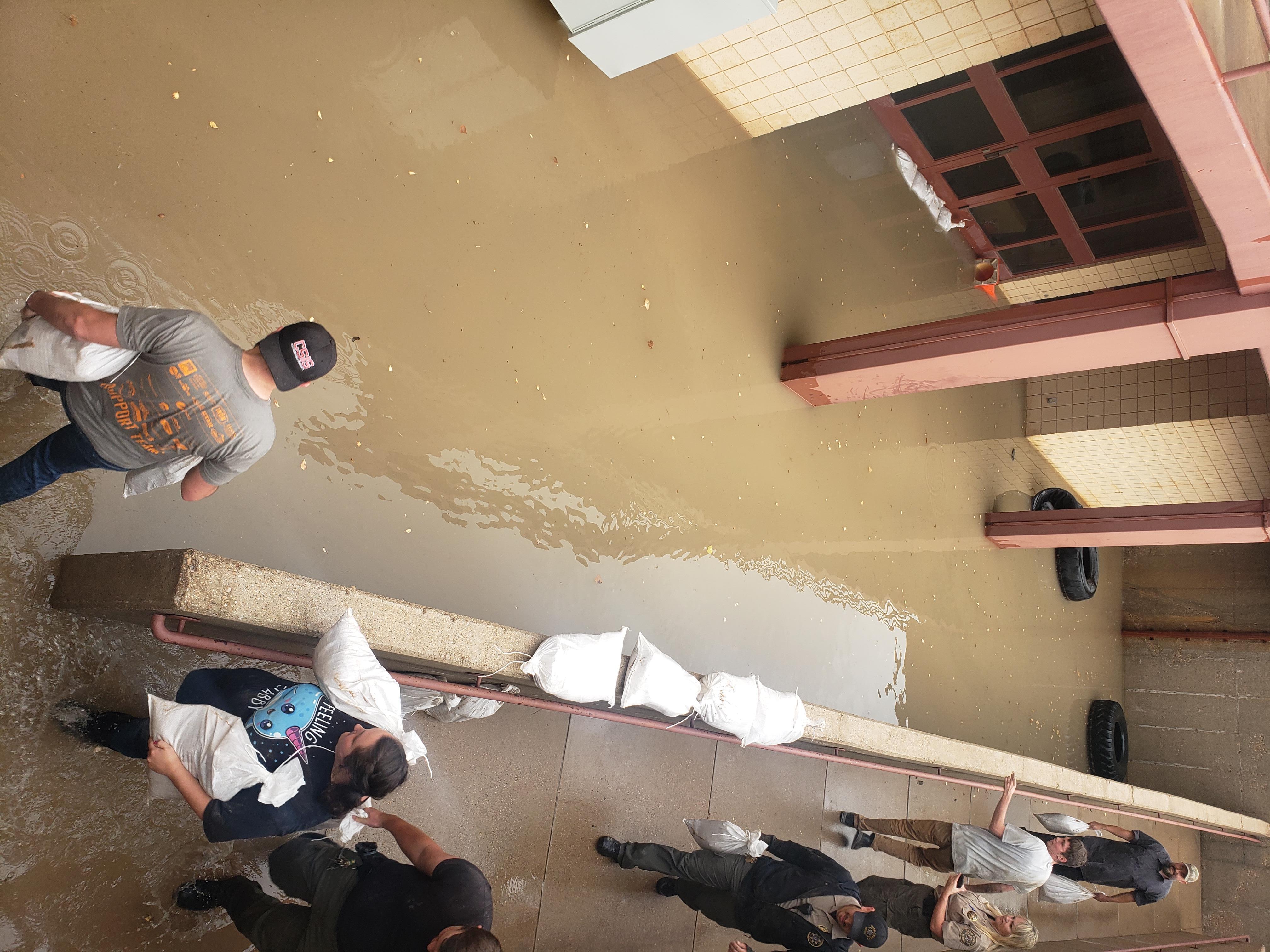 People work to sandbag the Iron County Sheriff’s Office and jail in Cedar City after heavy rain Thursday. Heavy rain flooded streets, homes, a hospital and the jail.