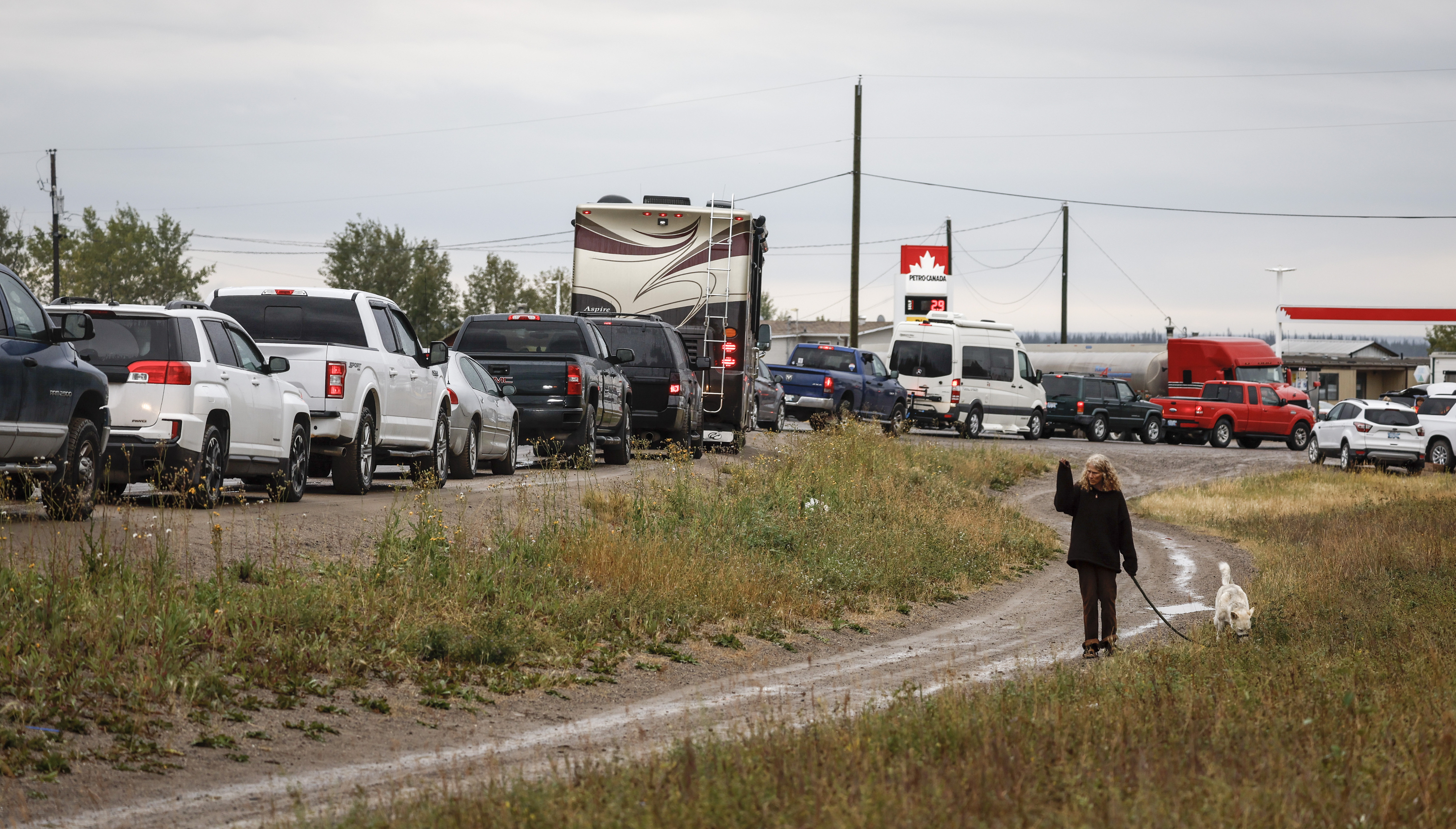 Vehicles line up for fuel at Fort Providence, Northwest Territories, on the only road south from Yellowknife, Thursday. Residents have heeded warnings to evacuate the capital of Canada's Northwest Territories as a wildfire burns just miles outside the city of 20,000.