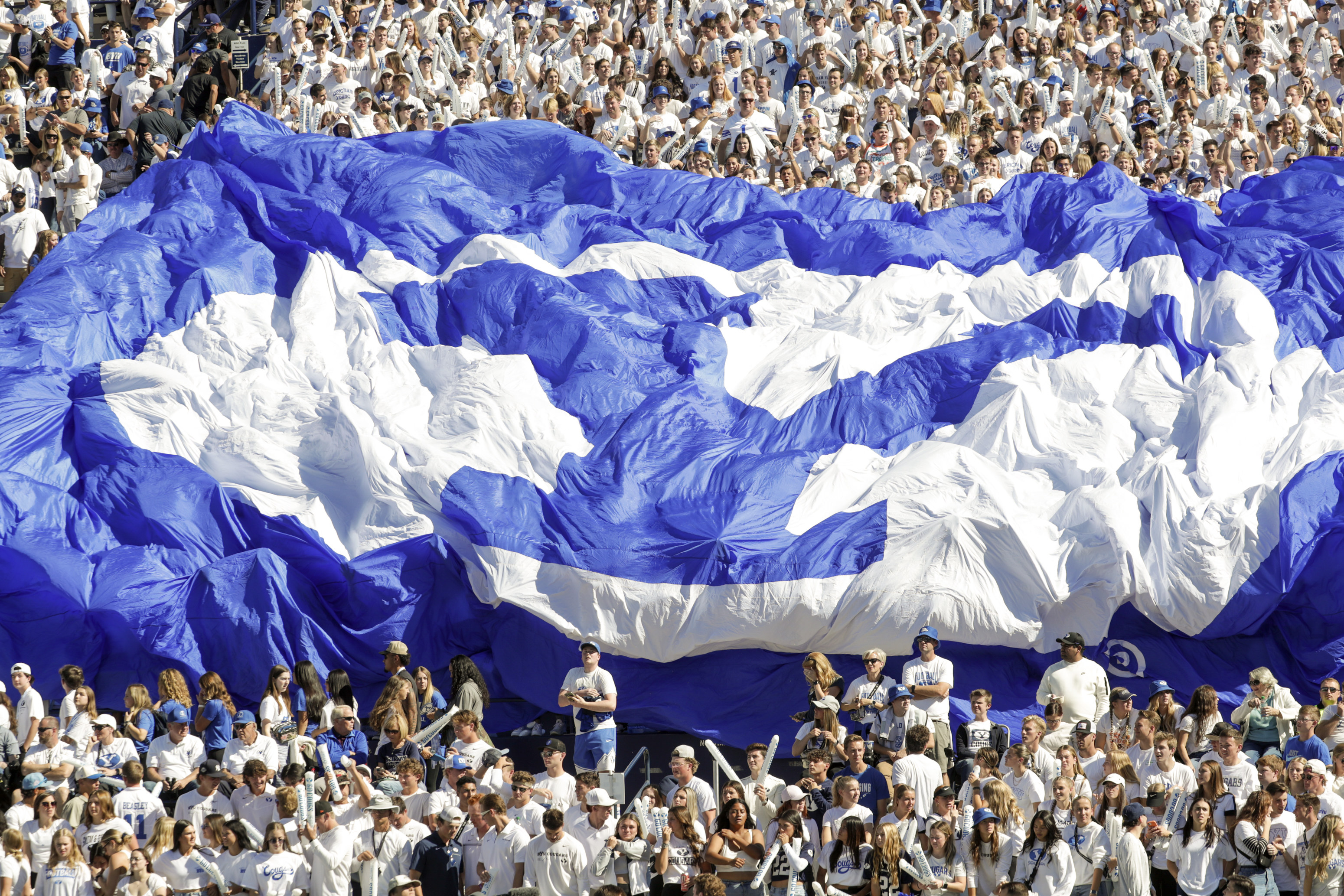 Fans in the student section hold up a BYU banner during a football game at LaVell Edwards Stadium in Provo on Oct. 15, 2022. The church announced an update to its Honor Code and dress and grooming standards for Church Educational System schools on Thursday.