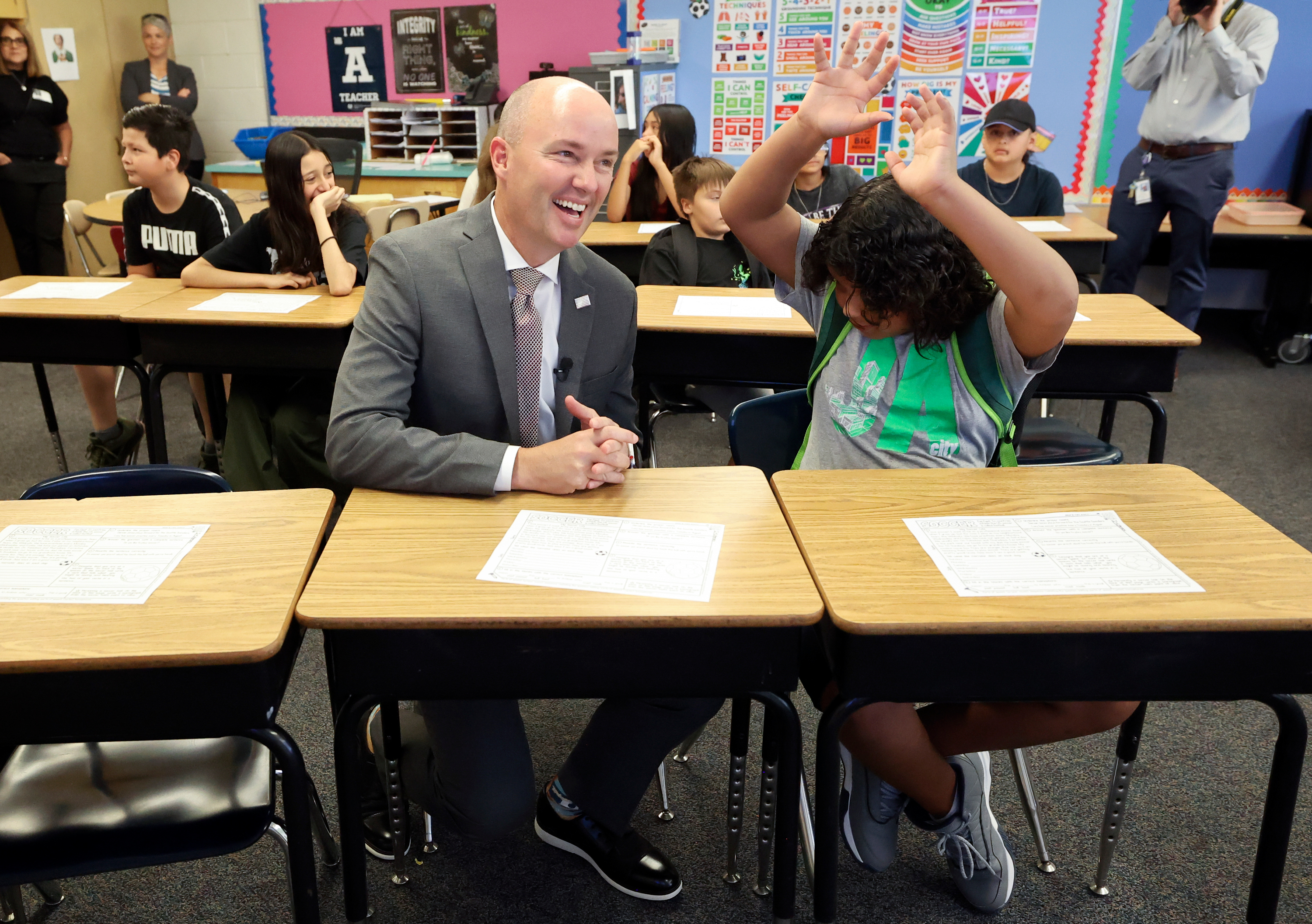 Utah Gov. Spencer Cox sits next to sixth grader Kevon Milo while visiting Magna Elementary School in Magna on Friday. 